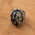 Black resin Queen Anne's Lace statement ring with filigree band worn on hand front view – EL-Creations