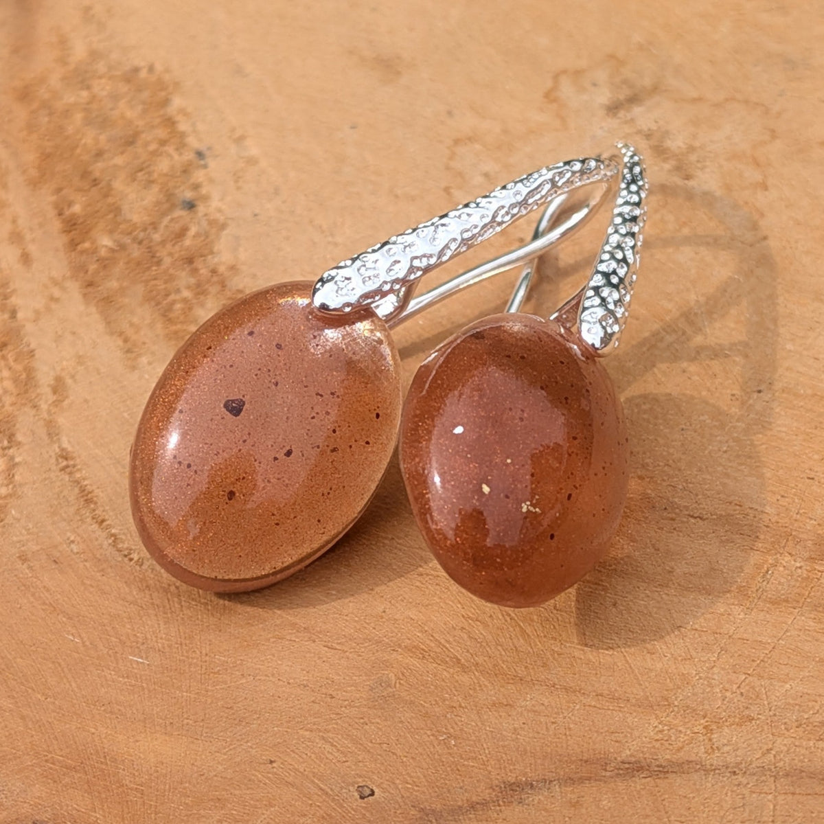 Handmade brown resin earrings 18x13mm oval cabochon with copper flakes on driftwood angled view – EL-Creations