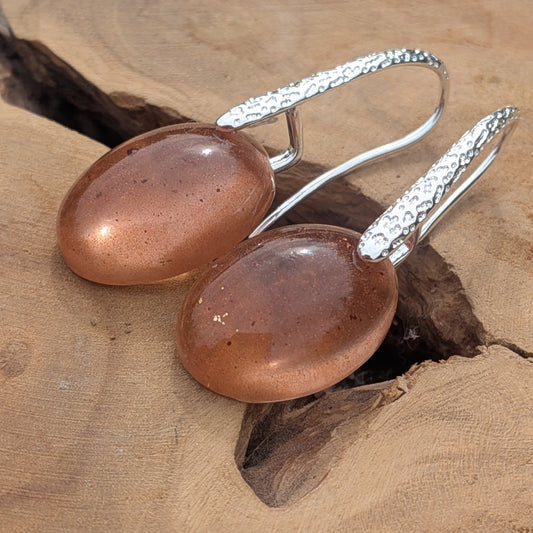 Minimalist brown resin earrings front view showing high-gloss dome and textured silver hook on wood – EL-Creations