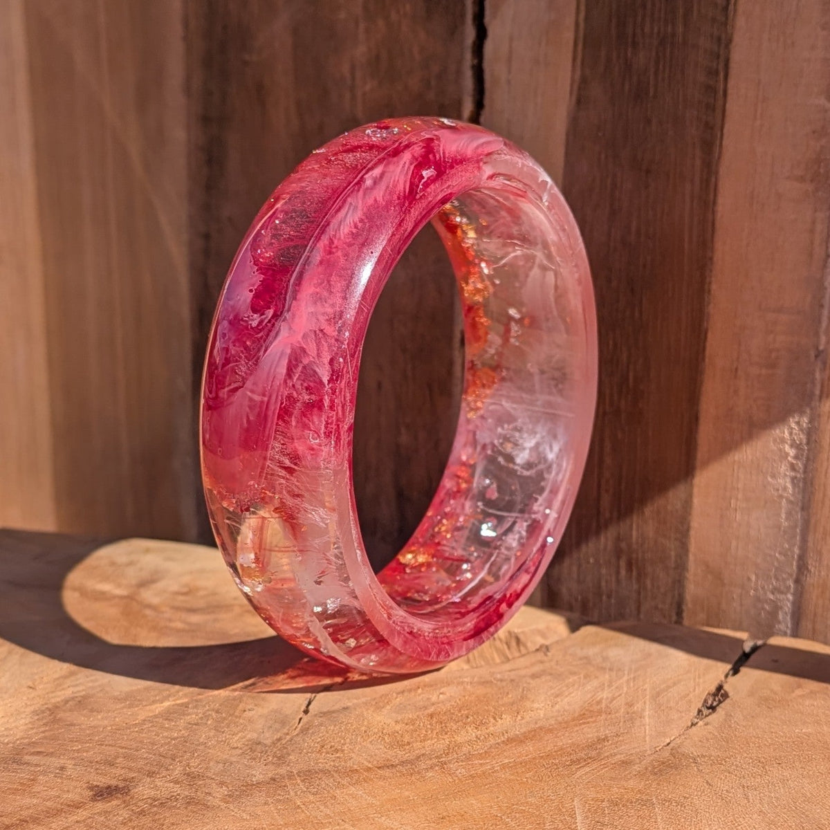 Handmade chunky resin bangle rose crimson pigment worn on wrist side view showing 23mm width outdoor – EL-Creations