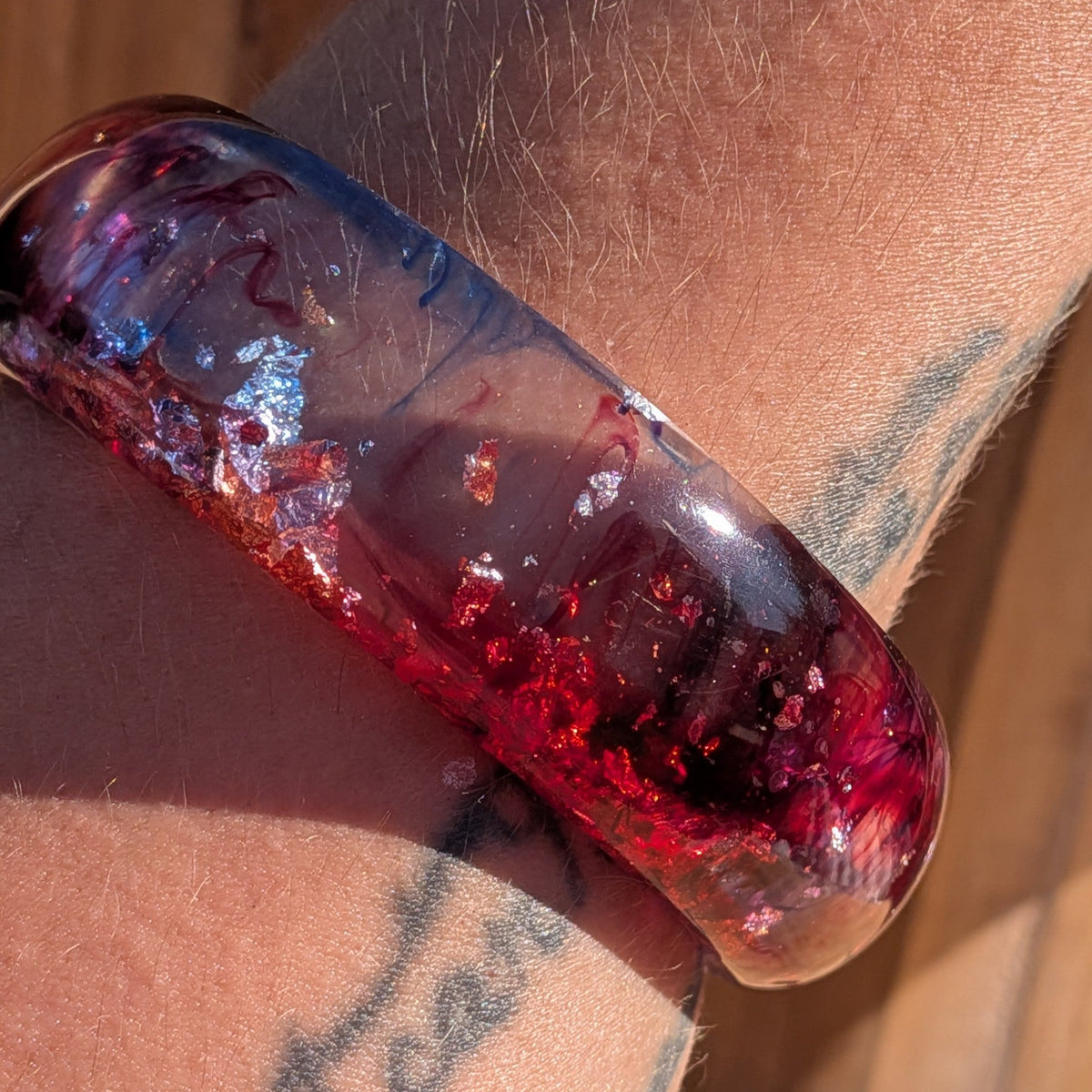 Handmade red and purple resin bangle 67mm inner diameter angled view showing metallic flake detail – EL-Creations