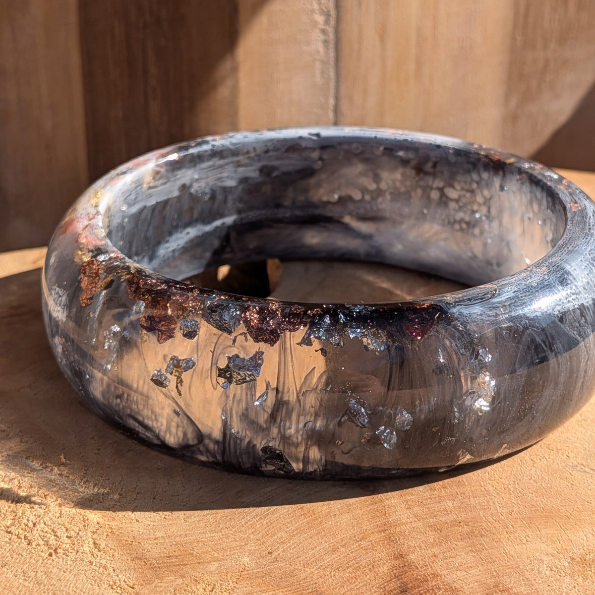 Black white resin statement bangle top view showing inner diameter 67mm and full swirl pattern on wood – EL-Creations