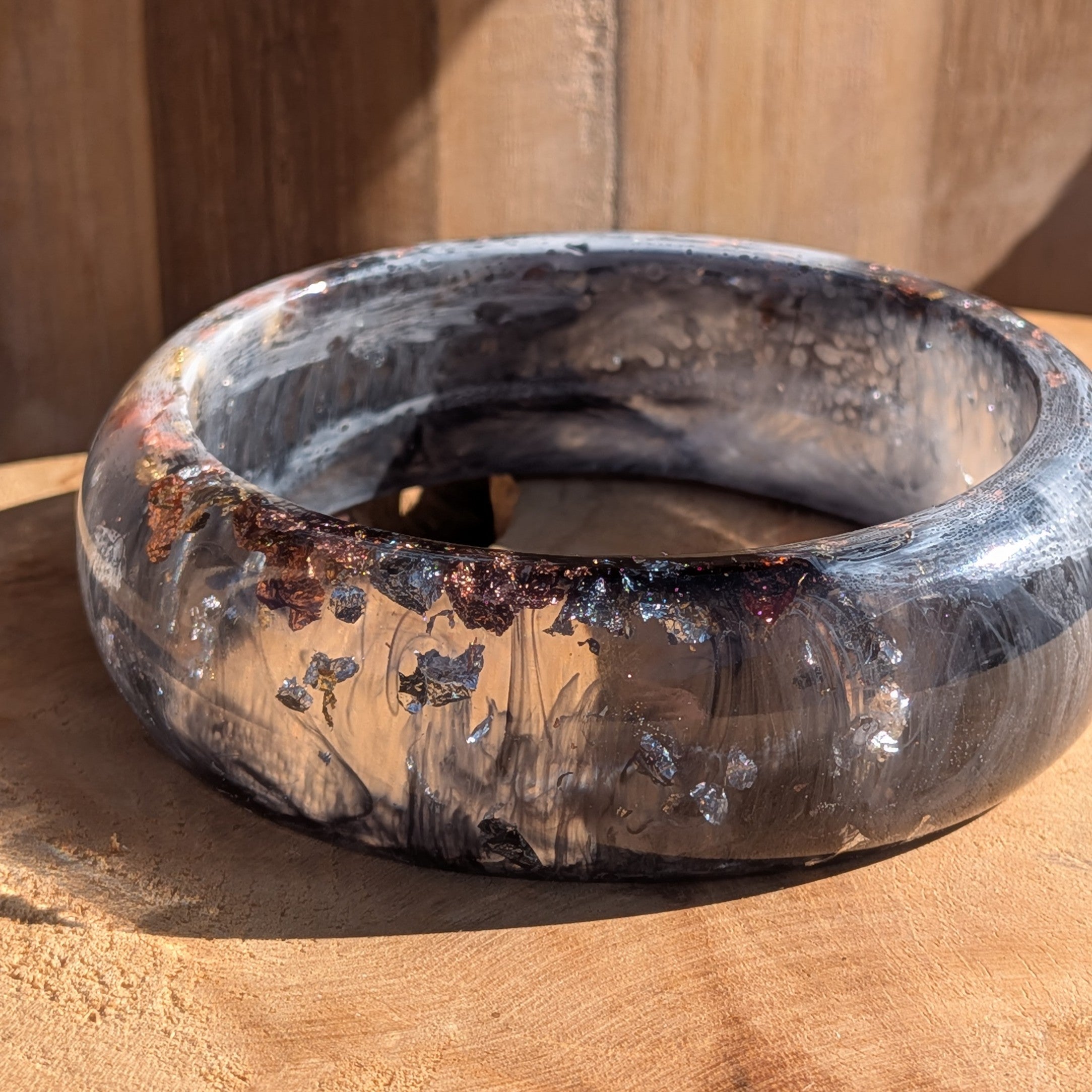 Black white resin statement bangle top view showing inner diameter 67mm and full swirl pattern on wood – EL-Creations