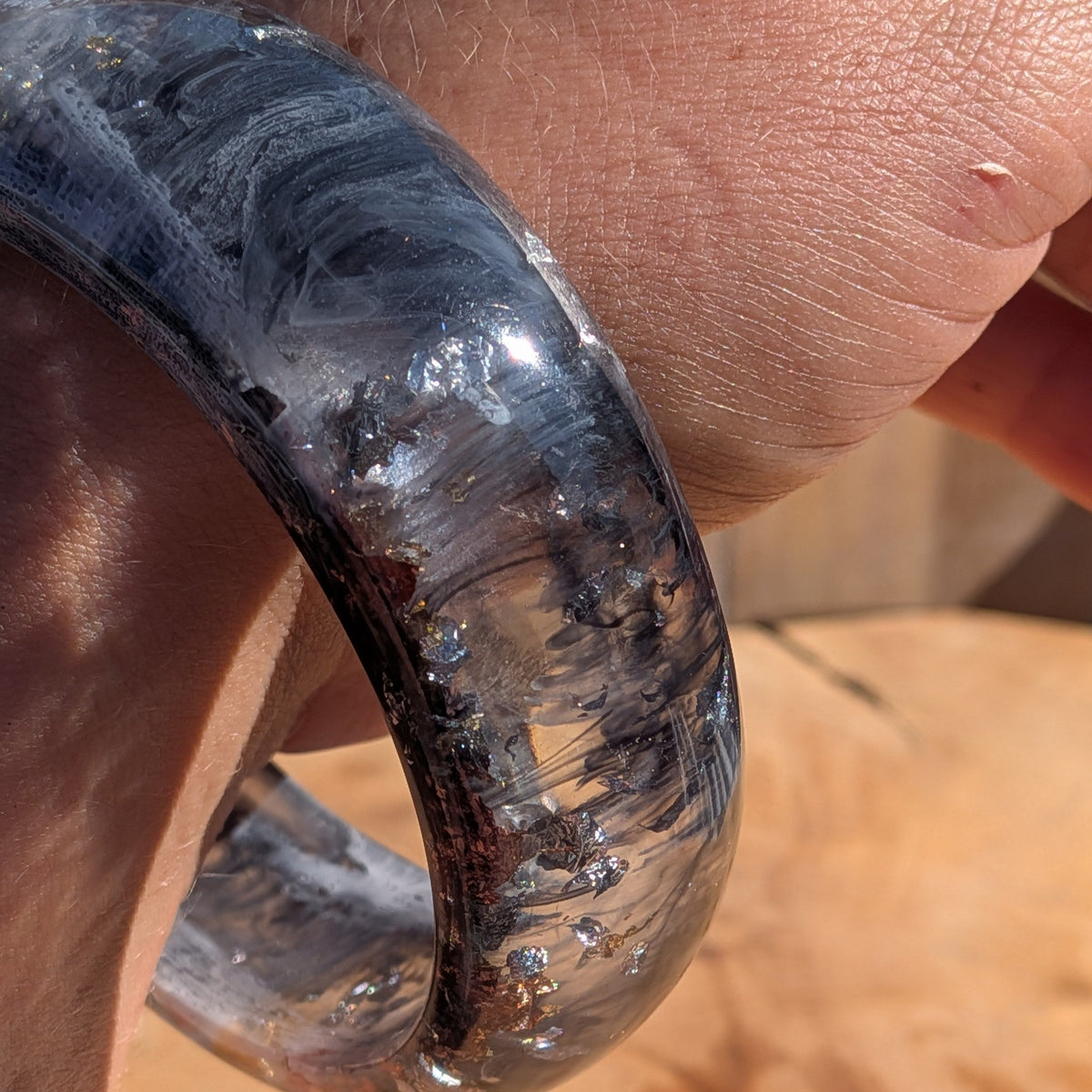 Bold monochrome resin bangle black white swirls gold copper flakes worn on wrist outdoor – EL-Creations