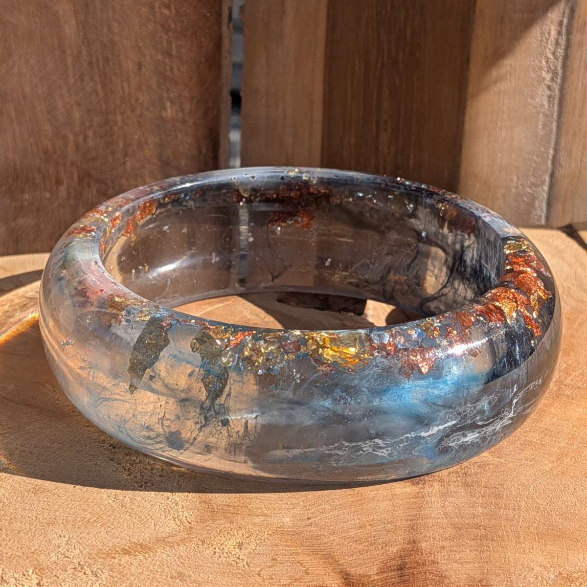 Handmade wide resin bangle 23mm blue navy pigment copper gold flakes side profile on wood – EL-Creations