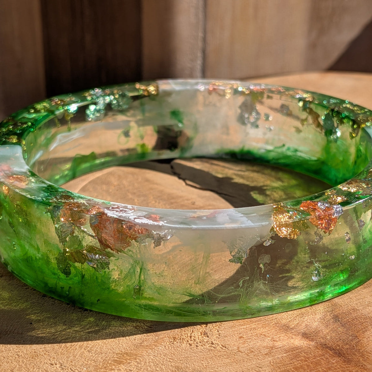 Green resin slip-on bangle worn on wrist front view showing full width and metallic flake detail – EL-Creations