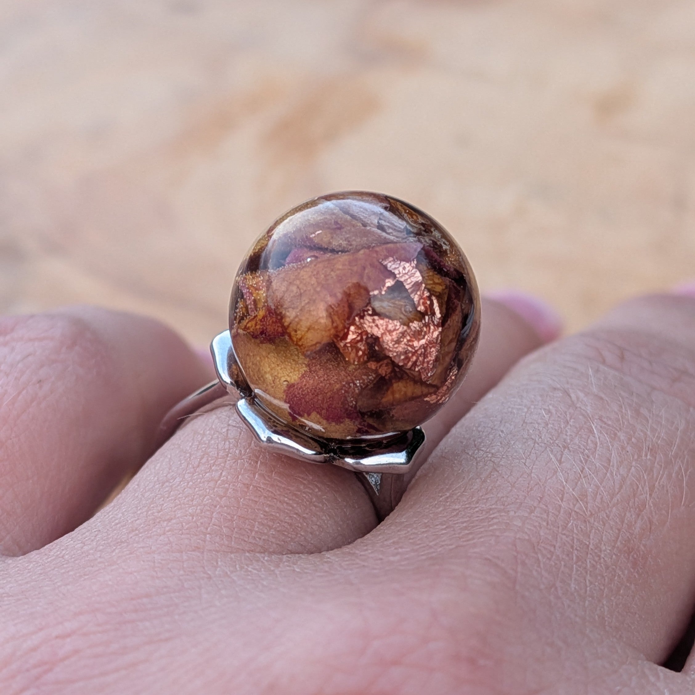 Handmade resin globe ring with rose petals and copper flakes – full hand view – EL-Creations