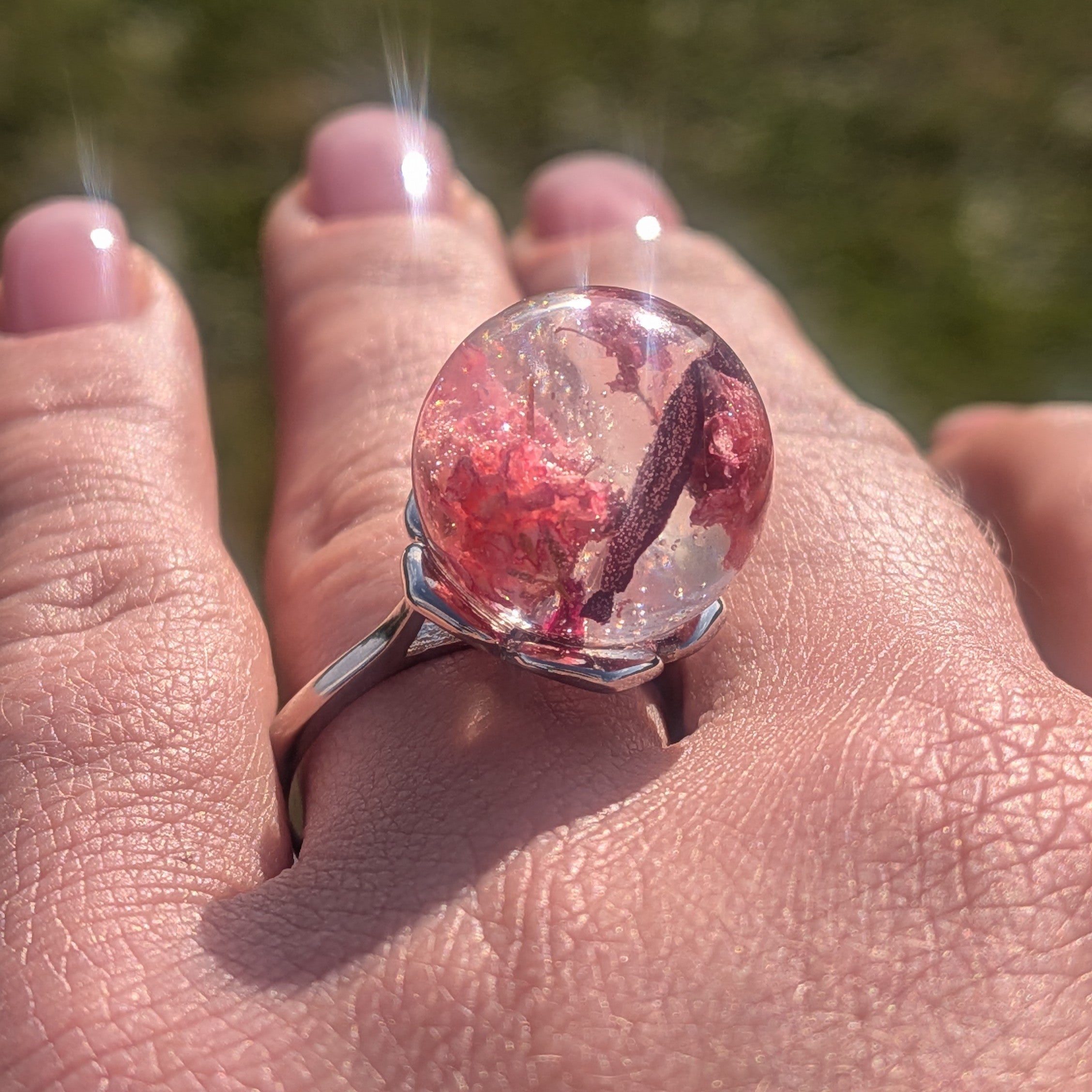 Resin globe ring with dried baby's breath and rose petals on wooden surface – EL-Creations