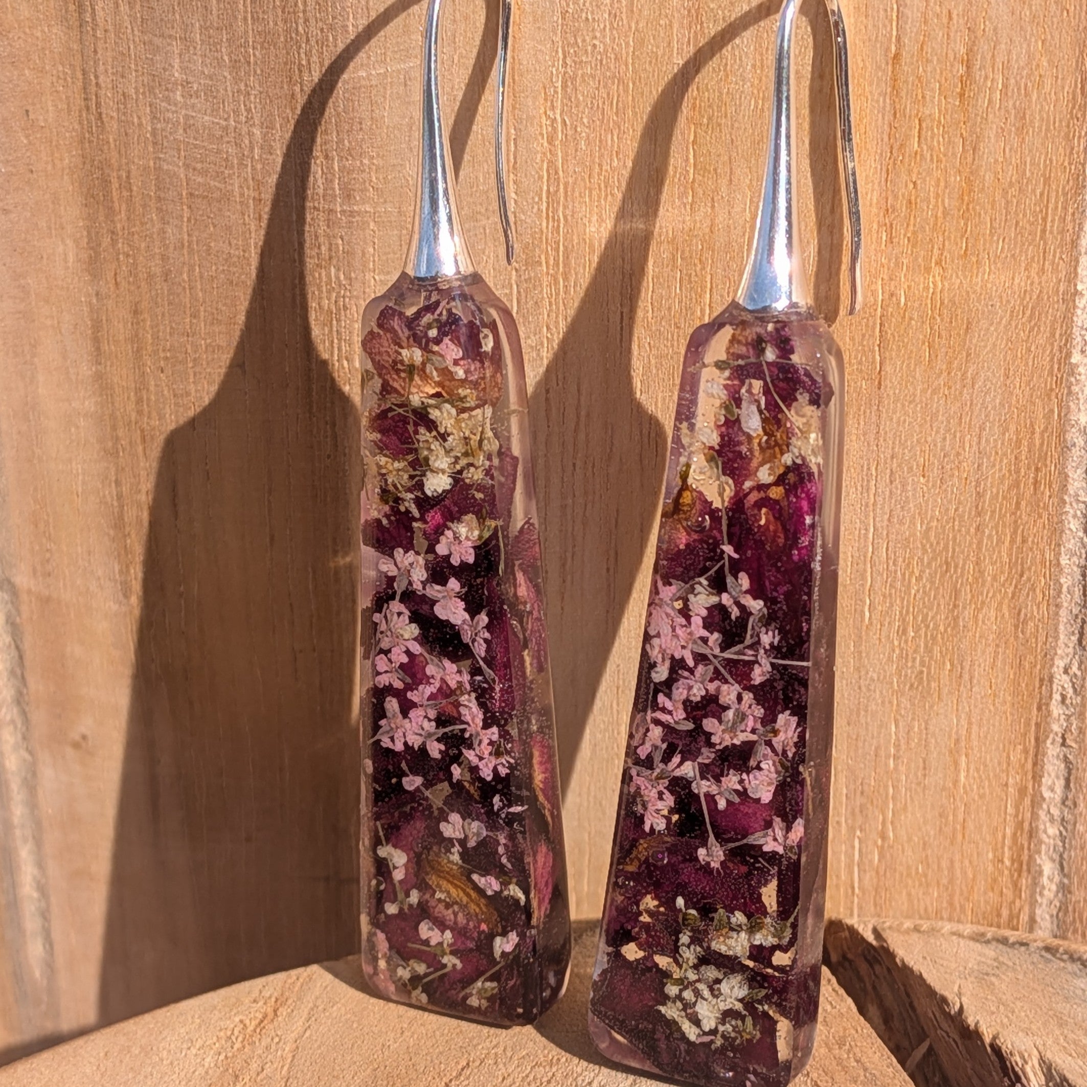 Handmade burgundy resin dangle earrings with rose petals and Queen Anne's Lace – close-up – EL-Creations