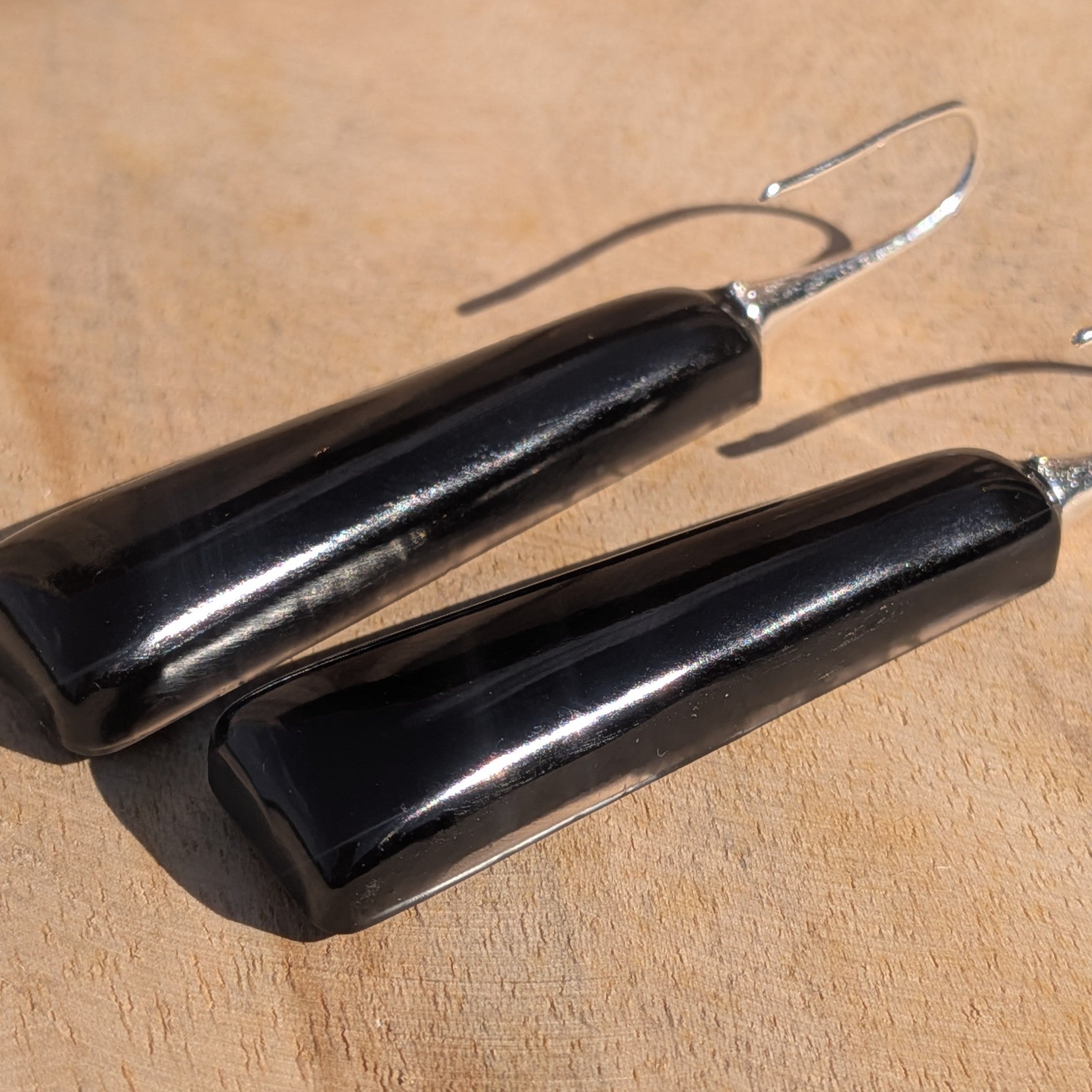 Black resin fern earrings – back view showing smooth glossy finish – EL-Creations