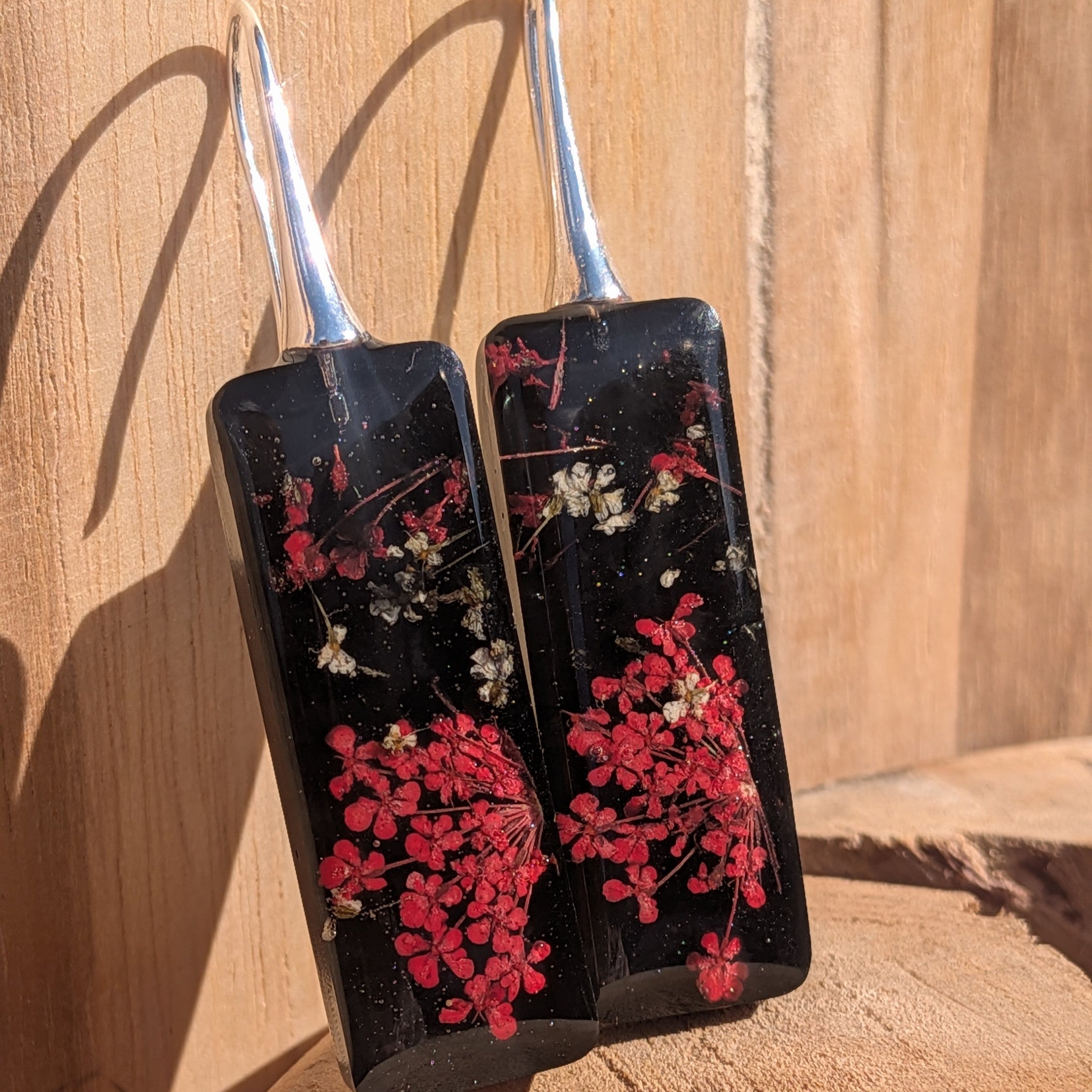 Botanical black resin earrings with red Queen Anne's Lace and baby's breath – pair on wood – EL-Creations