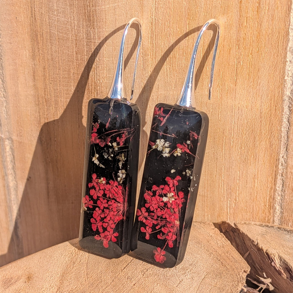 Black resin rectangular earrings with red and white botanical inclusions – silver hook detail – EL-Creations