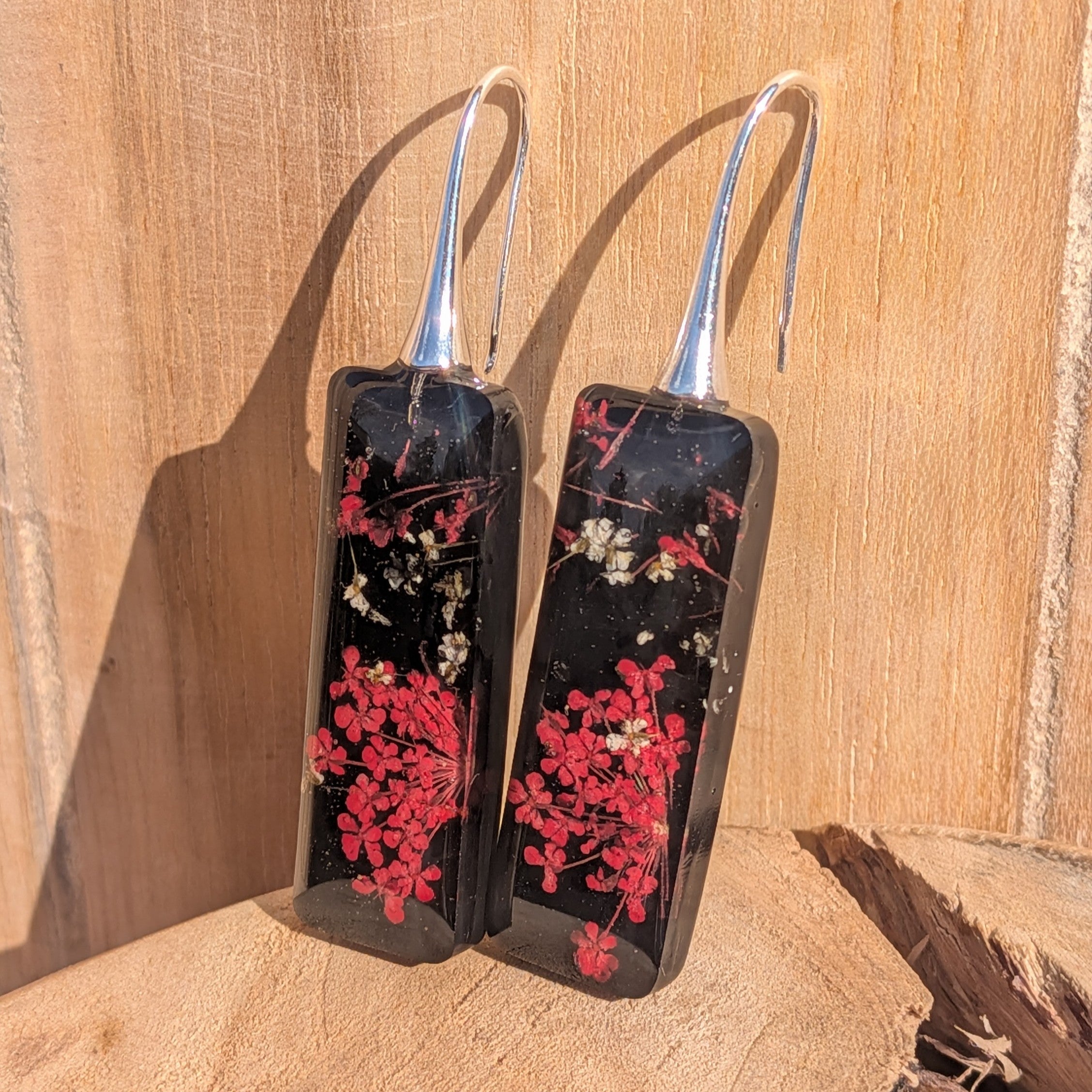 Black resin rectangular earrings with red and white botanical inclusions – silver hook detail – EL-Creations