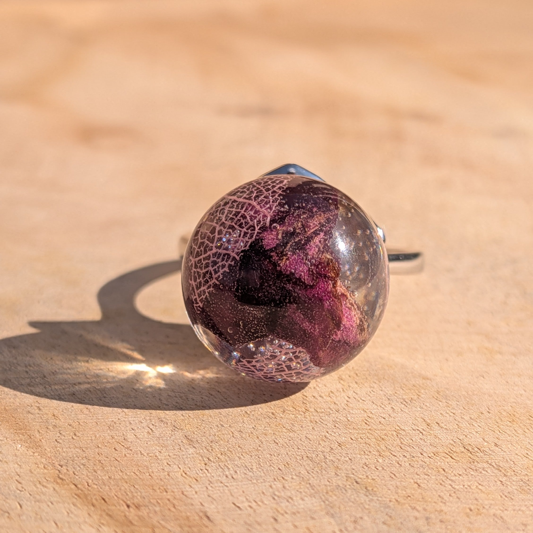 Handmade botanical resin globe ring with rose petals and skeleton leaf – bottom view of claw setting – EL-Creations