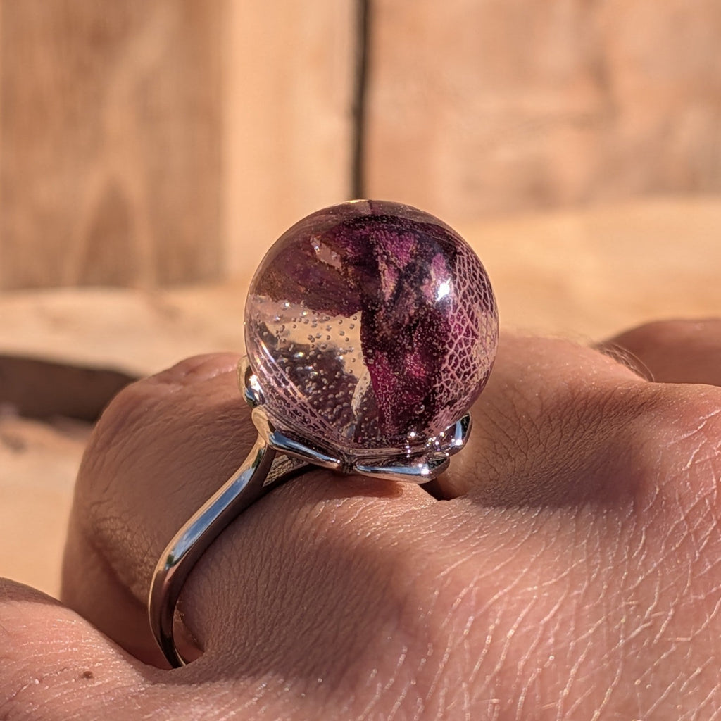Rose petals and skeleton leaf resin ring – silver adjustable band – close-up on hand – EL-Creations