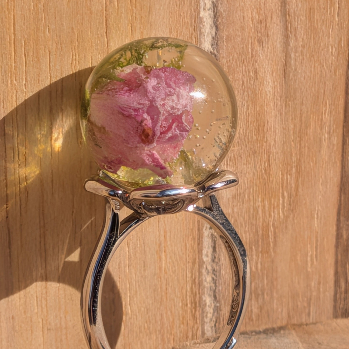 Mini rose and moss resin globe ring worn on finger close-up – EL-Creations