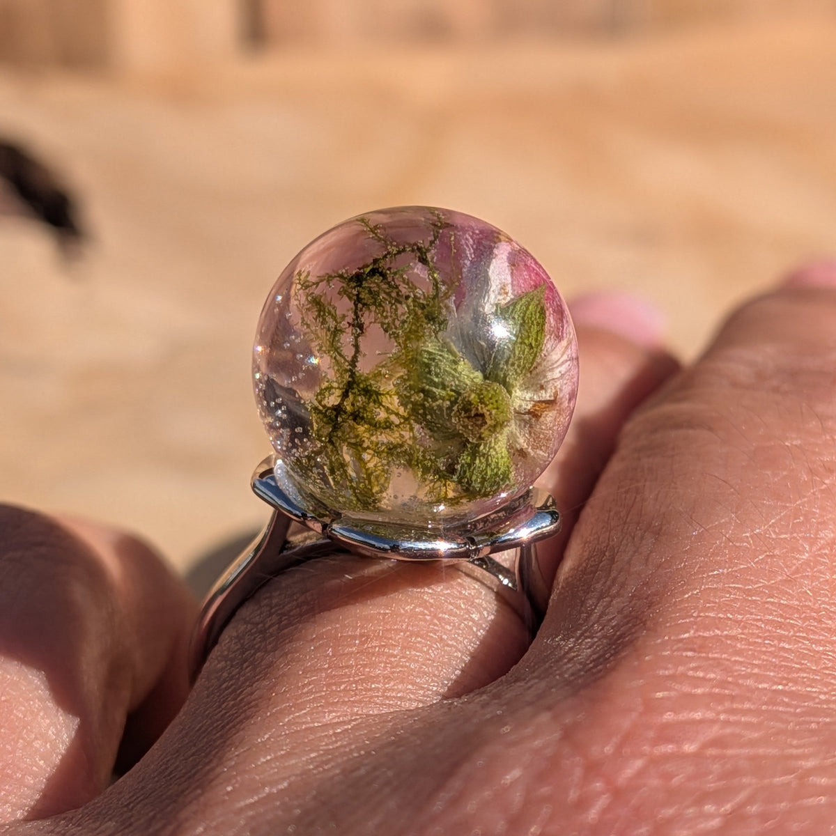Mini rose resin ring on silver adjustable band held between fingers – EL-Creations