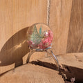 Globe resin ring with real pressed wildflowers and skeleton leaf – top view on wooden background – EL-Creations
