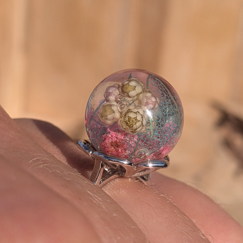 Resin sphere ring with real dried flowers on finger – baby's breath, skeleton leaf, pink wildflower – EL-Creations