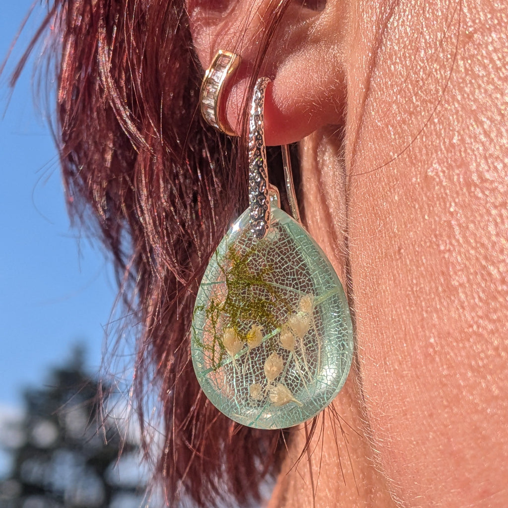 Skeleton leaf resin earrings silver filigree hooks front view on wood surface in sunlight – EL-Creations