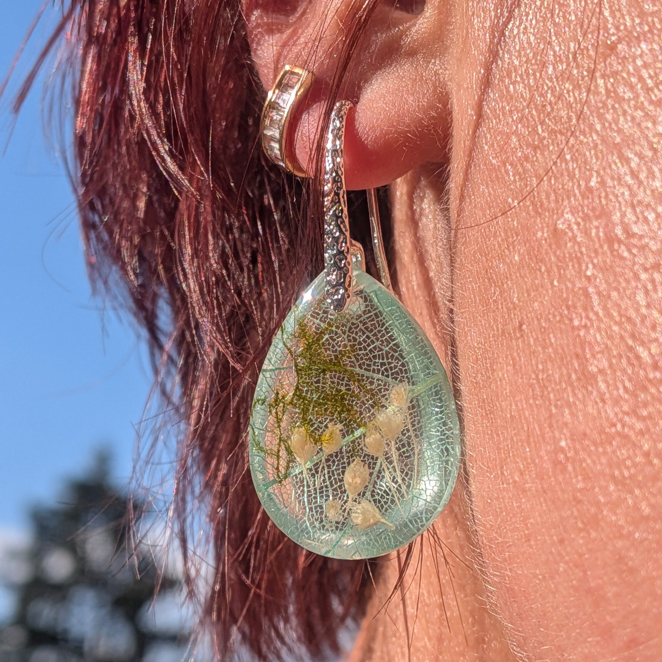 Skeleton leaf resin earrings silver filigree hooks front view on wood surface in sunlight – EL-Creations
