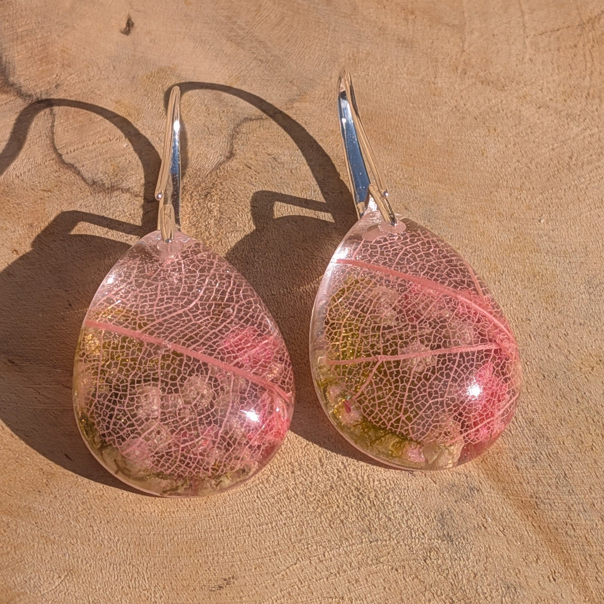 Pair of pink botanical resin earrings showing skeleton leaf veining pattern – EL-Creations