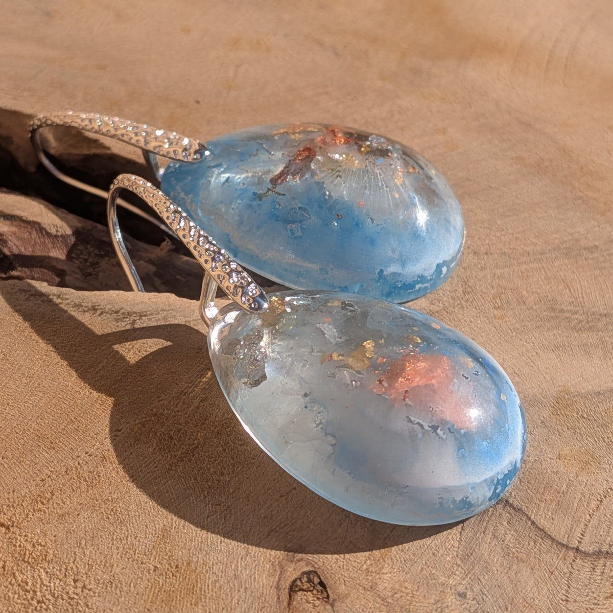 Abstract resin earrings with blue and white swirls and copper flakes on wood, EL-Creations