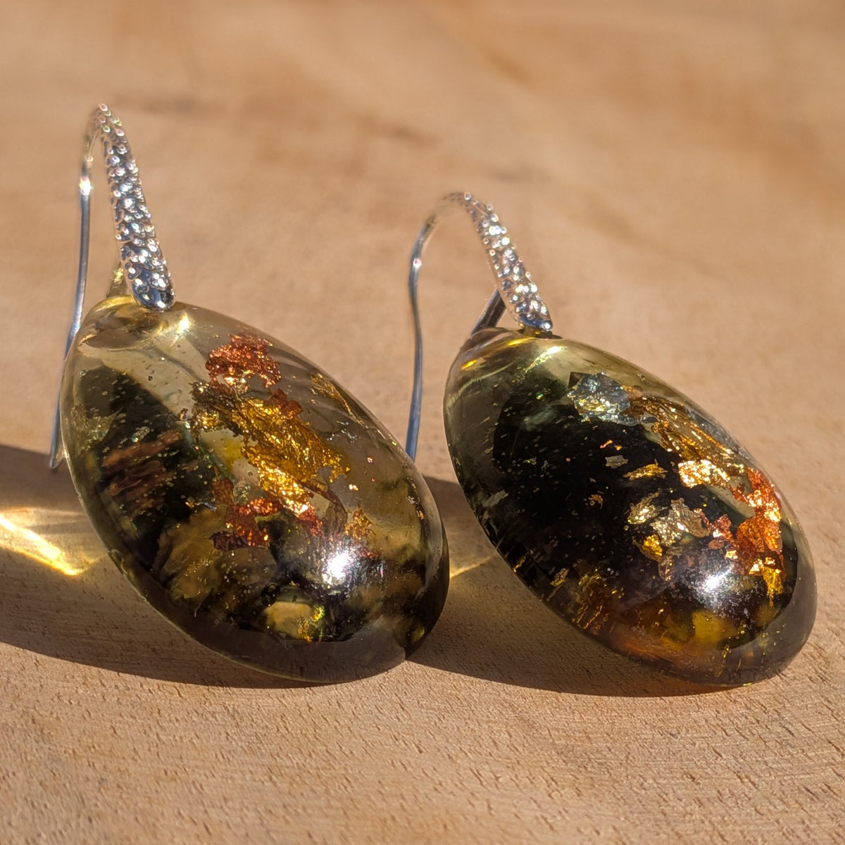 Glossy olive green resin drop earrings with metallic details on wood, EL-Creations