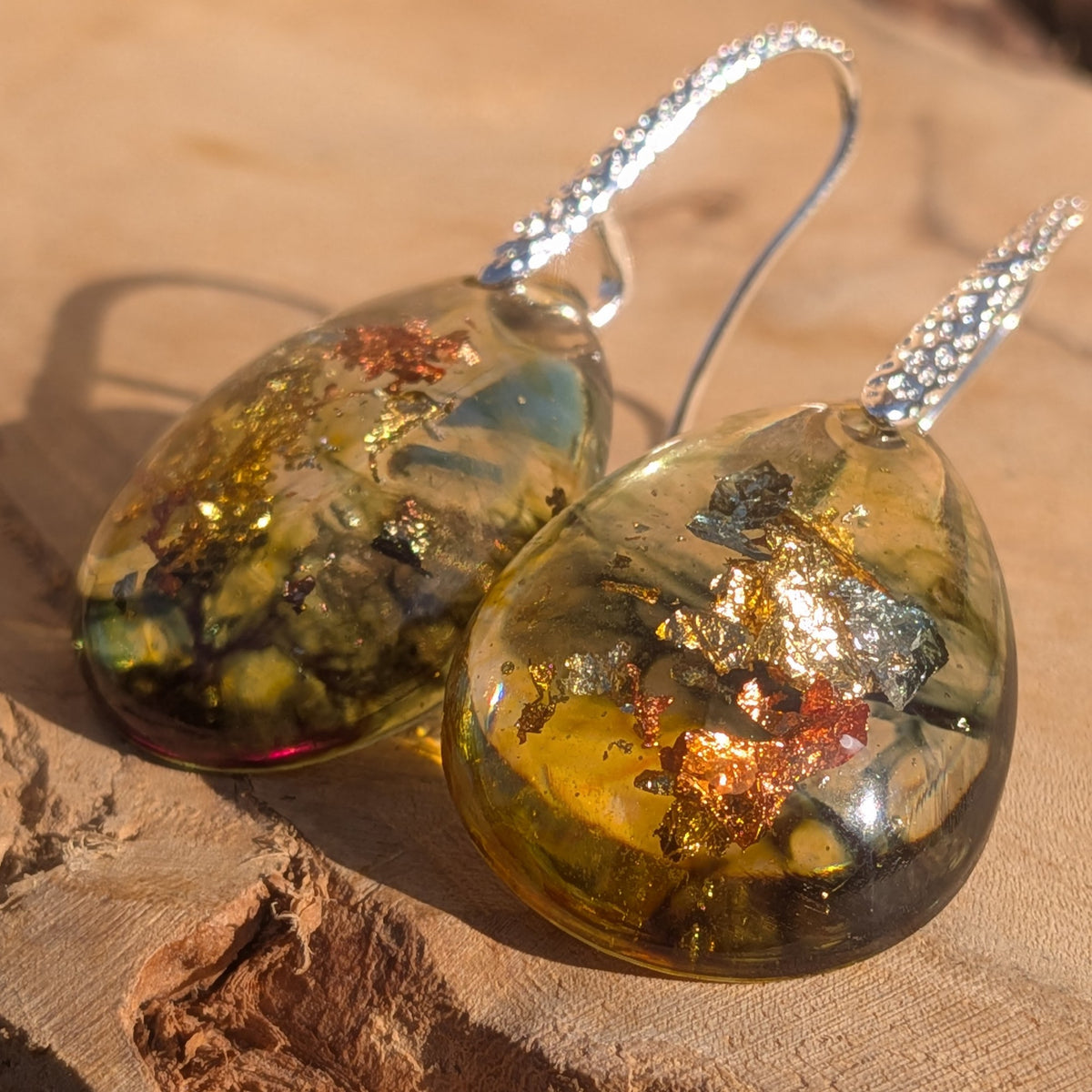 Close-up of olive green resin earrings with copper, gold and silver flakes, EL-Creations