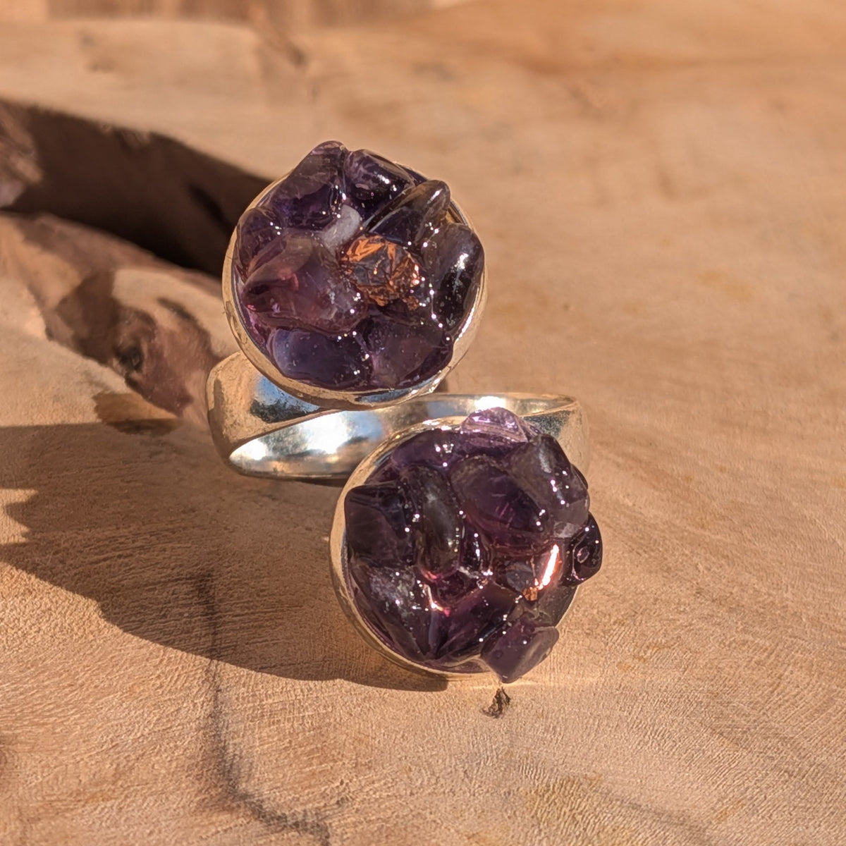 Purple amethyst ring with two round settings and silver flakes in sunlight, EL-Creations