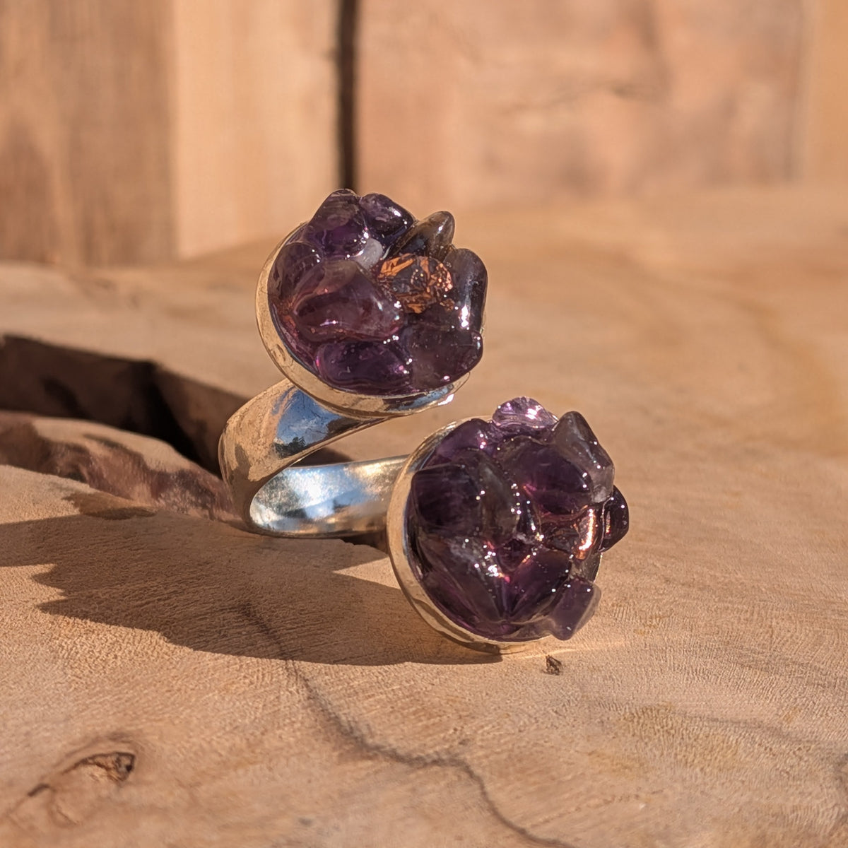 Handmade adjustable amethyst double stone ring with a silver-coloured alloy band on wood, EL-Creations