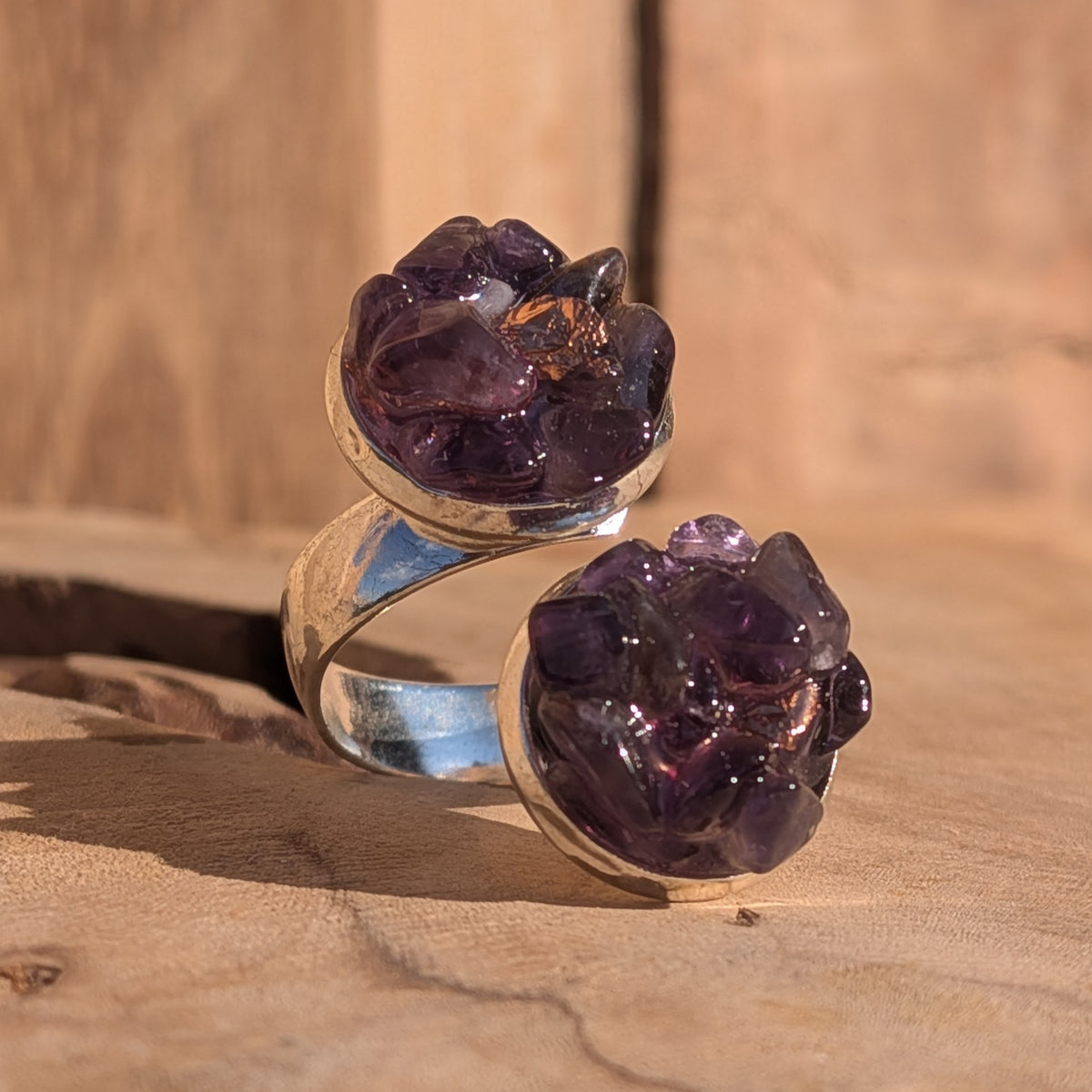 Front close-up of the double amethyst ring showing its open silver-coloured band, EL-Creations
