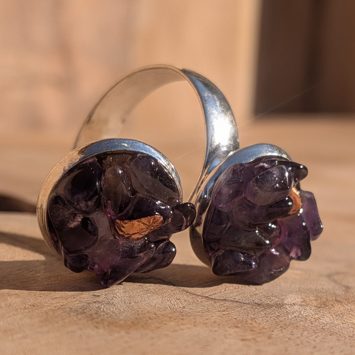 Macro view of amethyst pieces and silver flakes in the ring's two circular settings, EL-Creations