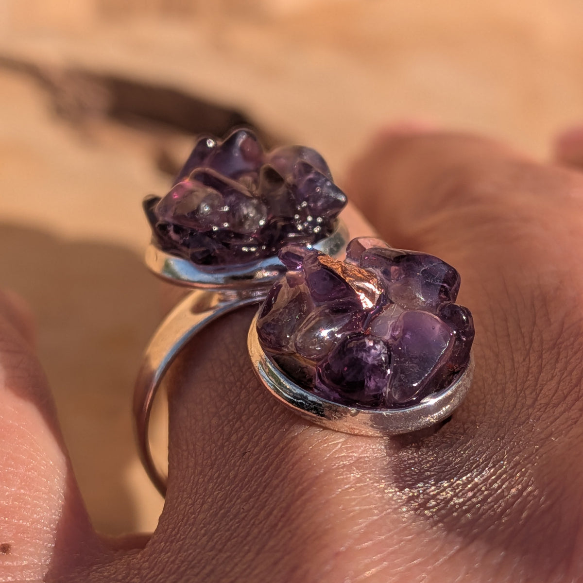 Angled close-up of the amethyst double stone ring worn on a finger, EL-Creations