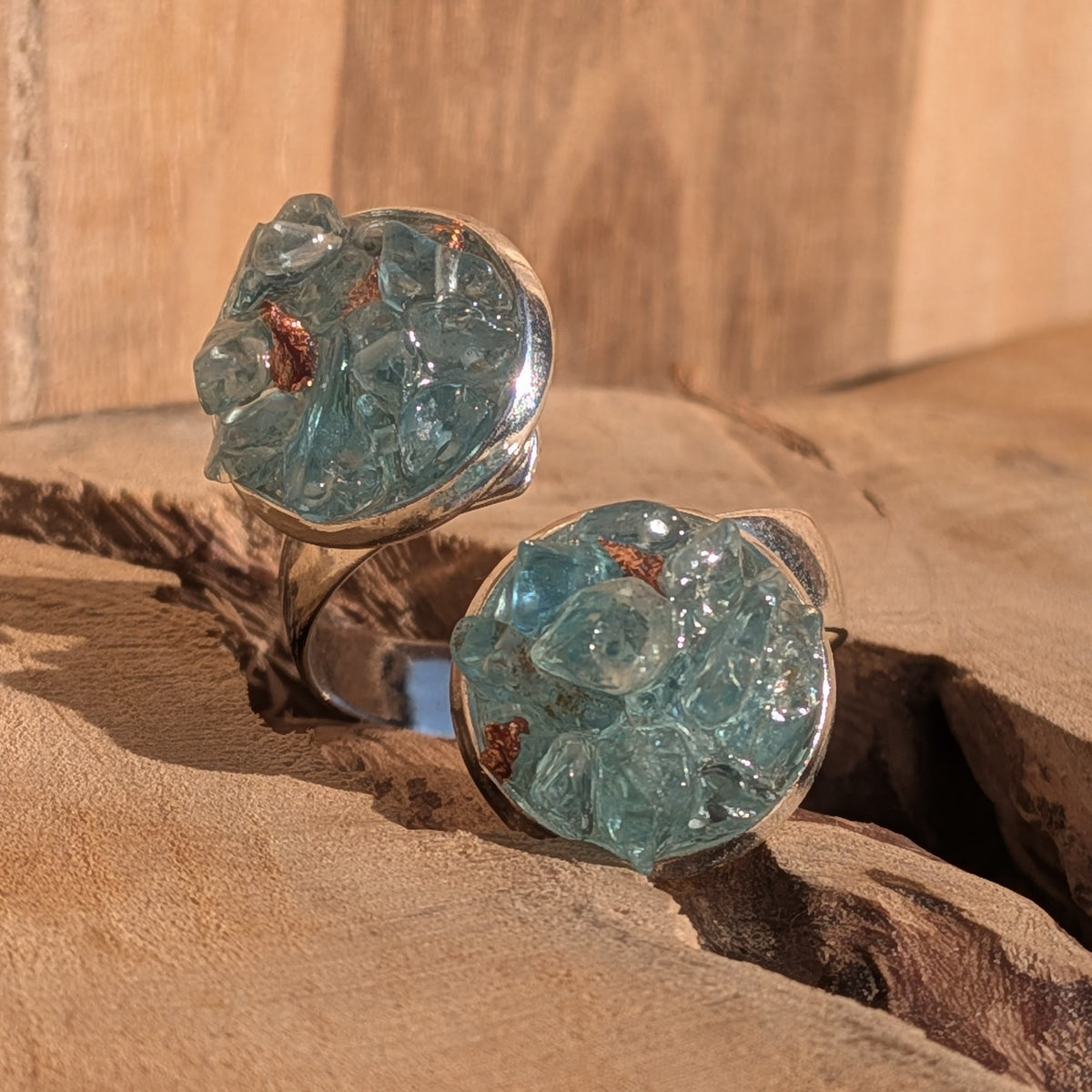 Front view of the blue topaz ring with two round gemstone cluster settings, EL-Creations