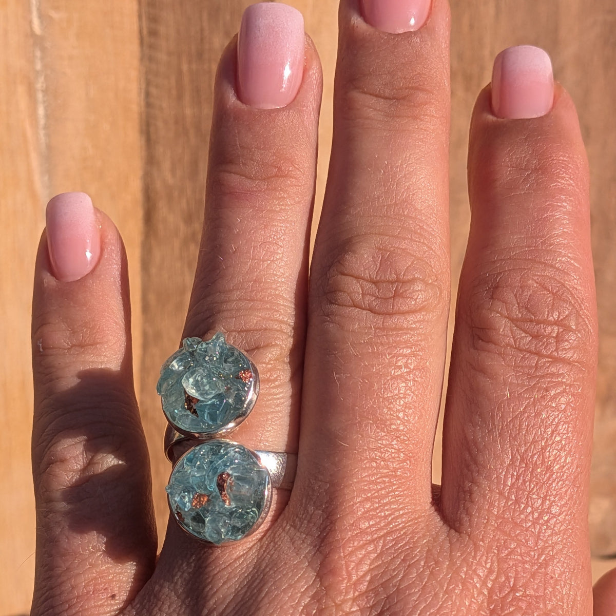 Blue topaz double cluster statement ring shown on a hand for scale, EL-Creations