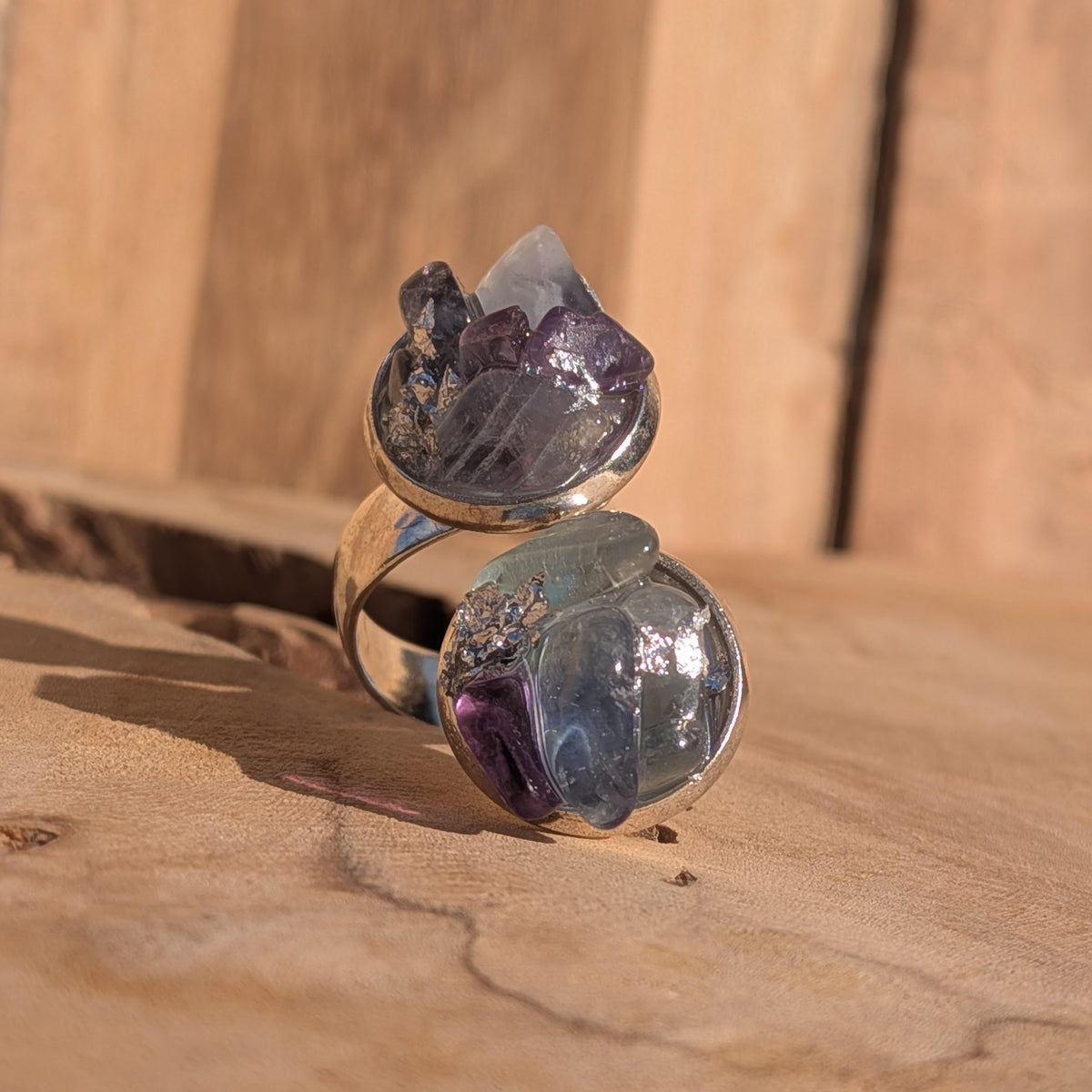 Fluorite double cluster ring displayed on wood in sunlight, EL-Creations