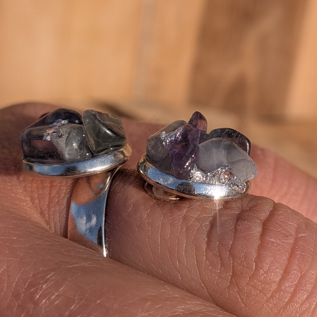 Close-up of the adjustable fluorite ring showing translucent stones and silver-coloured setting rims, EL-Creations