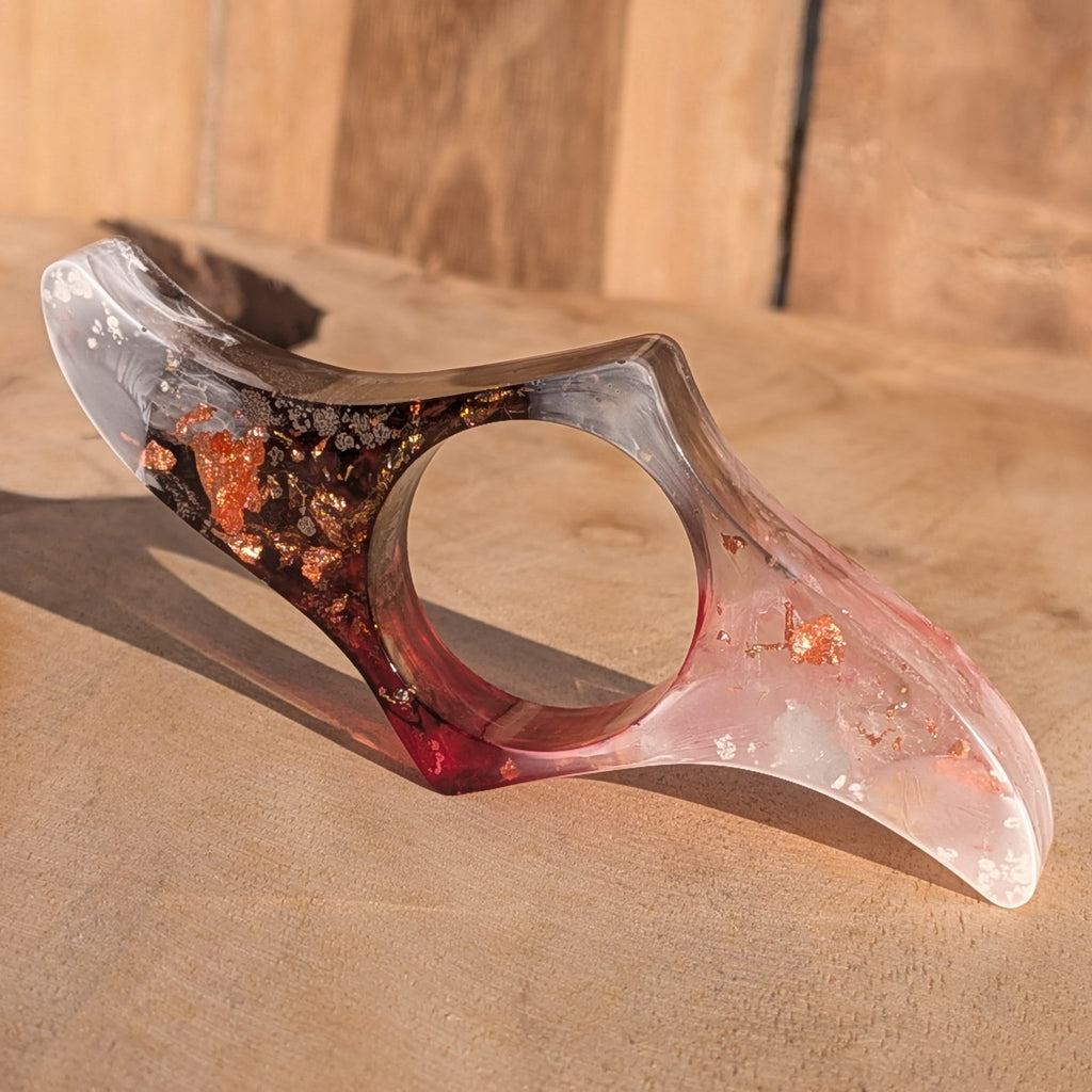 Handmade resin book ring with copper flakes and burgundy black gradient on sandy wooden surface – EL-Creations