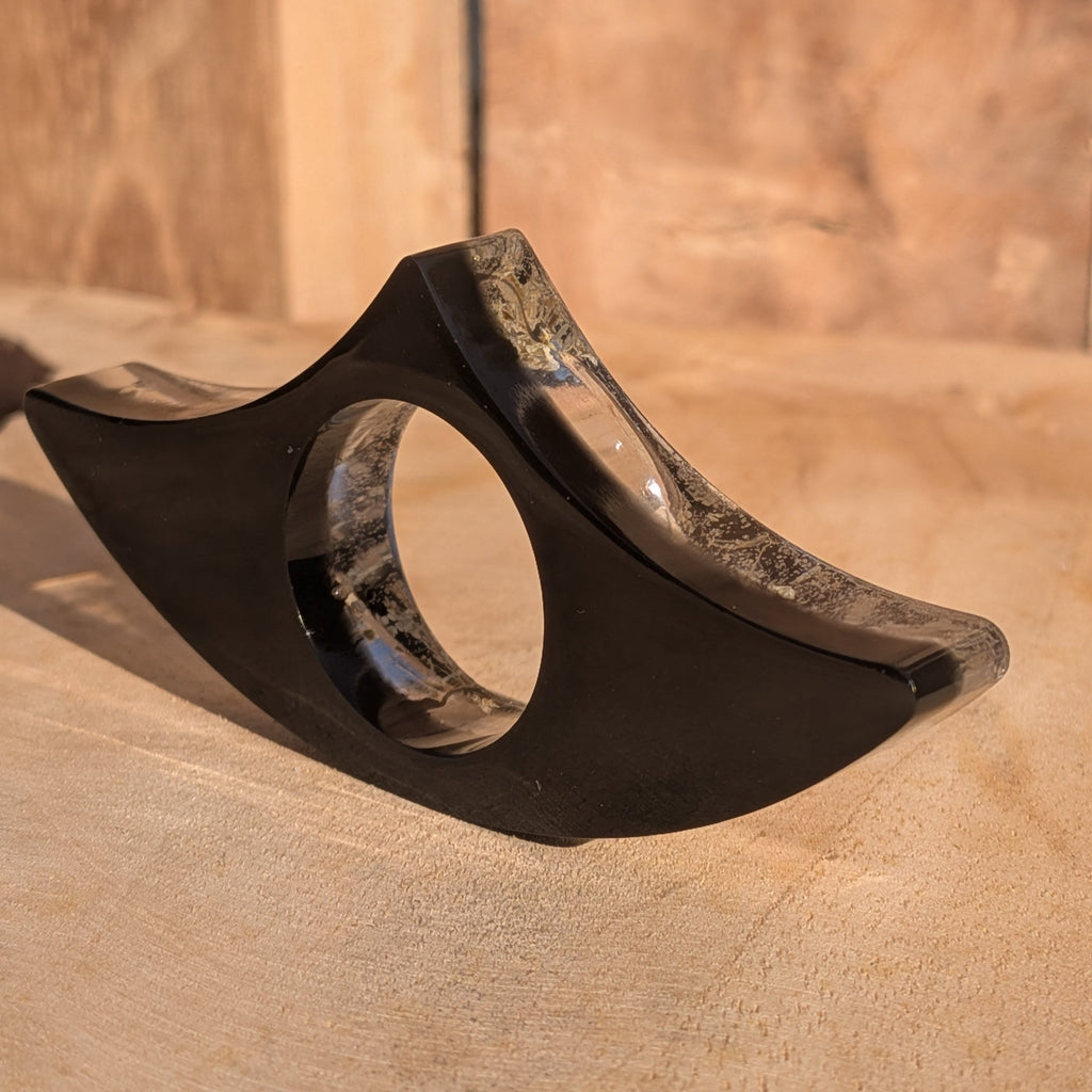 Black resin book ring with Queen Anne's Lace – wing shaped silhouette on wooden surface – EL-Creations