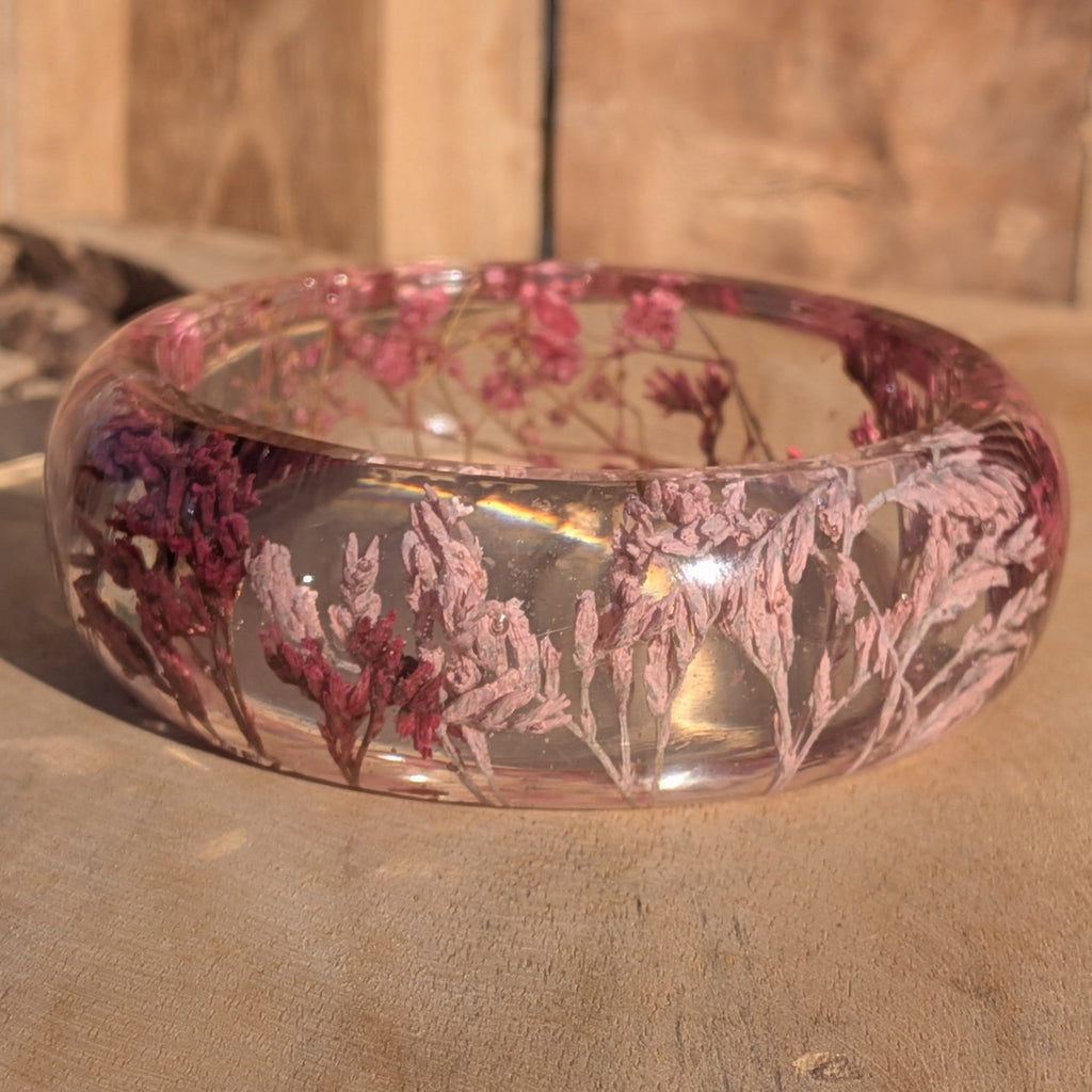 Resin bangle with dried pink wild flowers – side view showing domed profile and glossy finish – EL-Creations