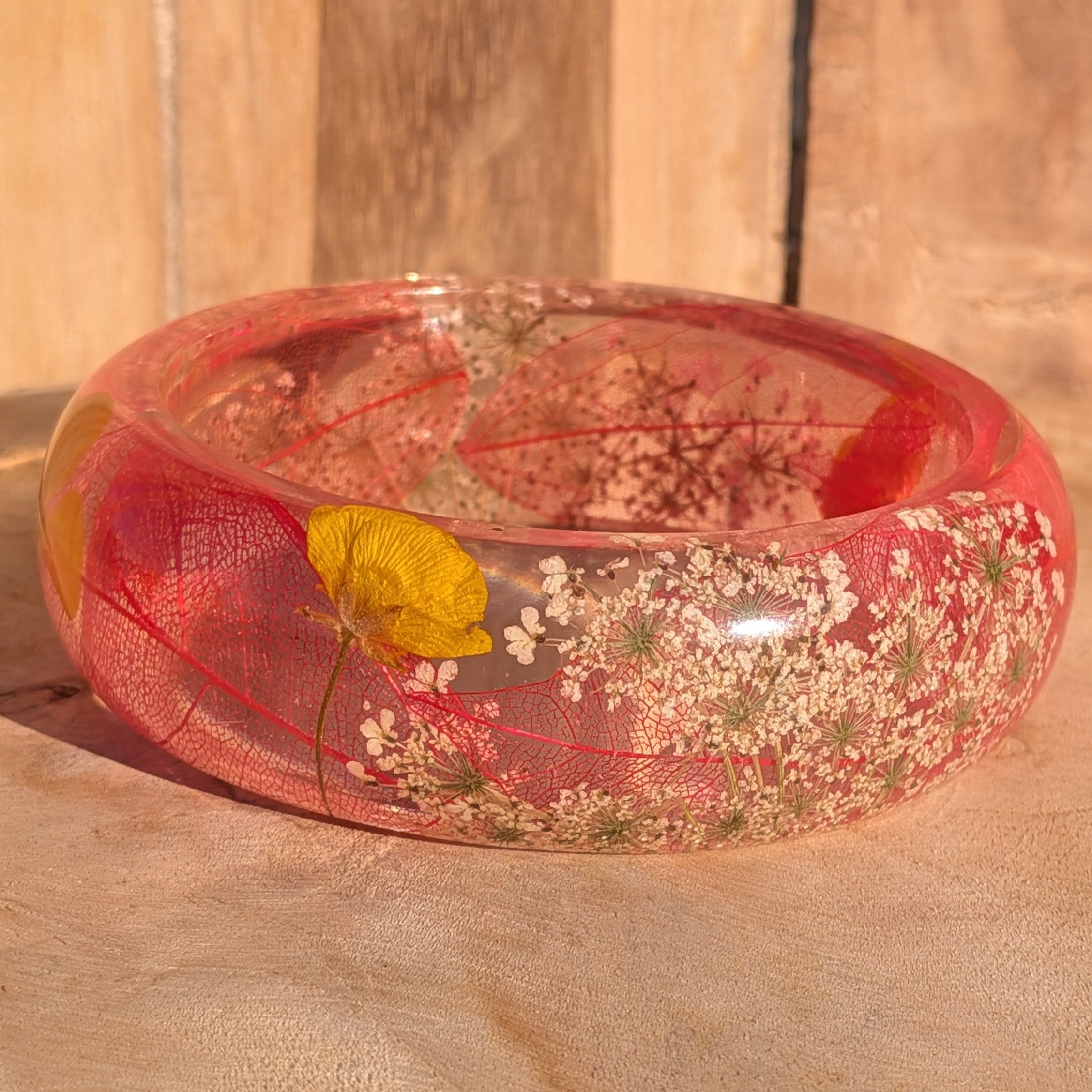 Handmade resin bangle with red skeleton leaf and Queen Anne's Lace – close-up detail on wooden background – EL-Creations