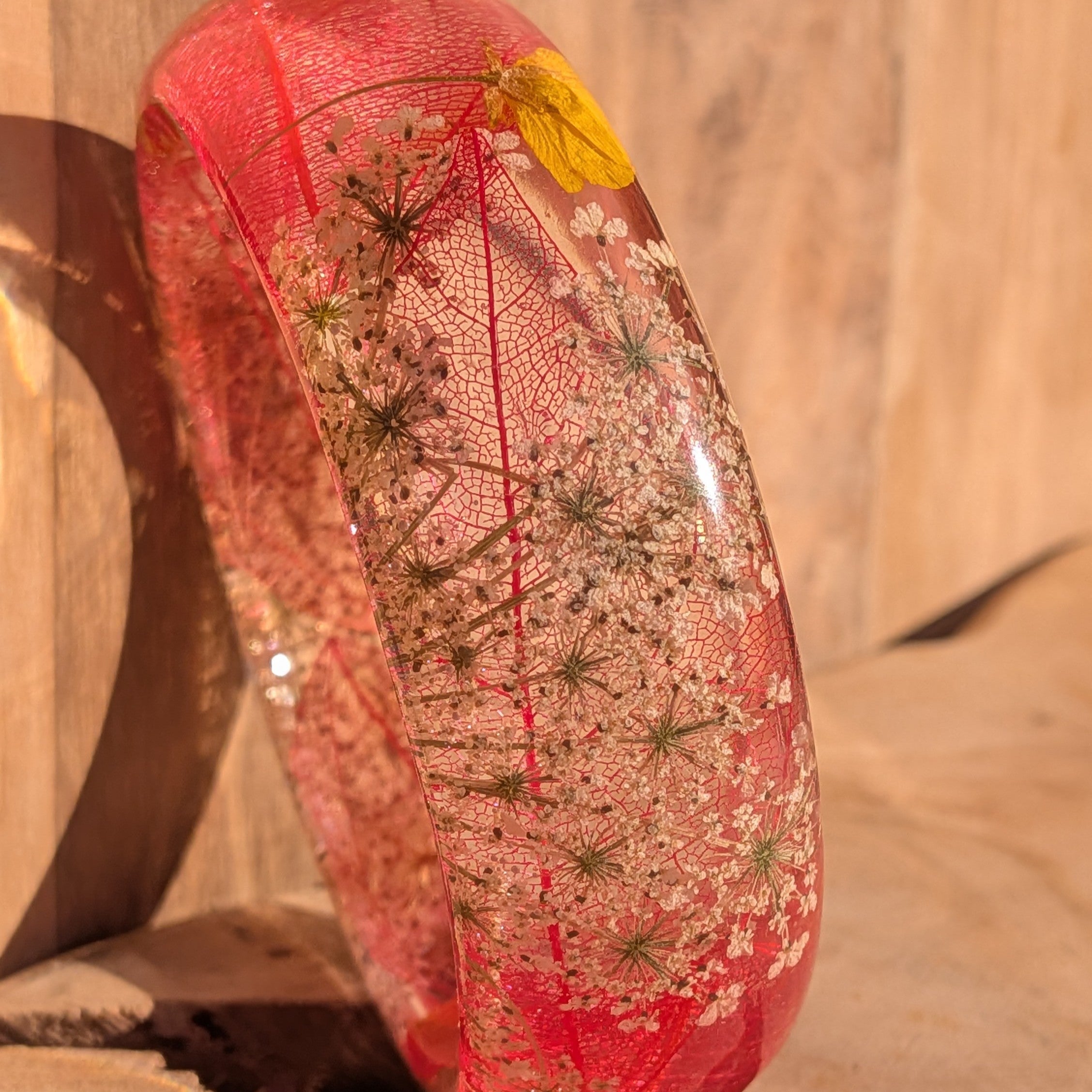 Resin botanical bracelet with skeleton leaf and wildflowers – close-up of flower detail on wrist – EL-Creations