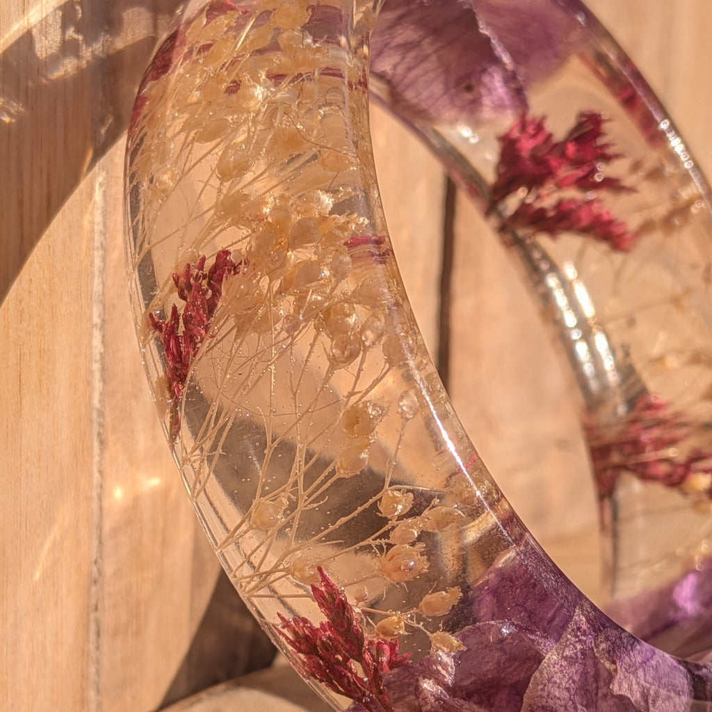 Botanical resin bangle with purple orchid petals – worn on wrist showing fit and scale – EL-Creations