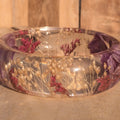 Clear flower resin bangle with purple orchid petals and red heather – botanical jewelry detail shot on wooden surface – EL-Creations