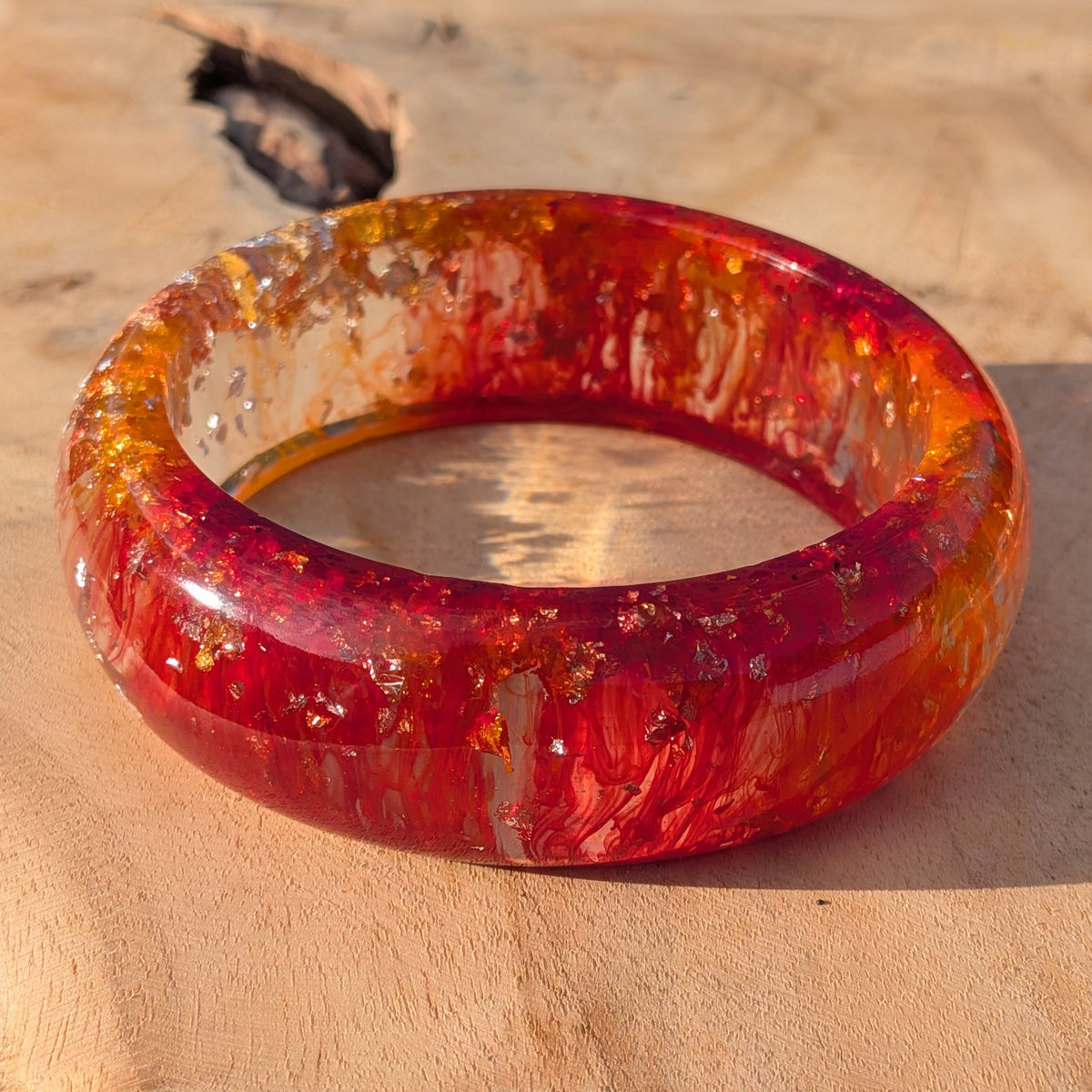 Close-up of phoenix fire resin bangle outer surface with gold and orange swirl detail – EL-Creations