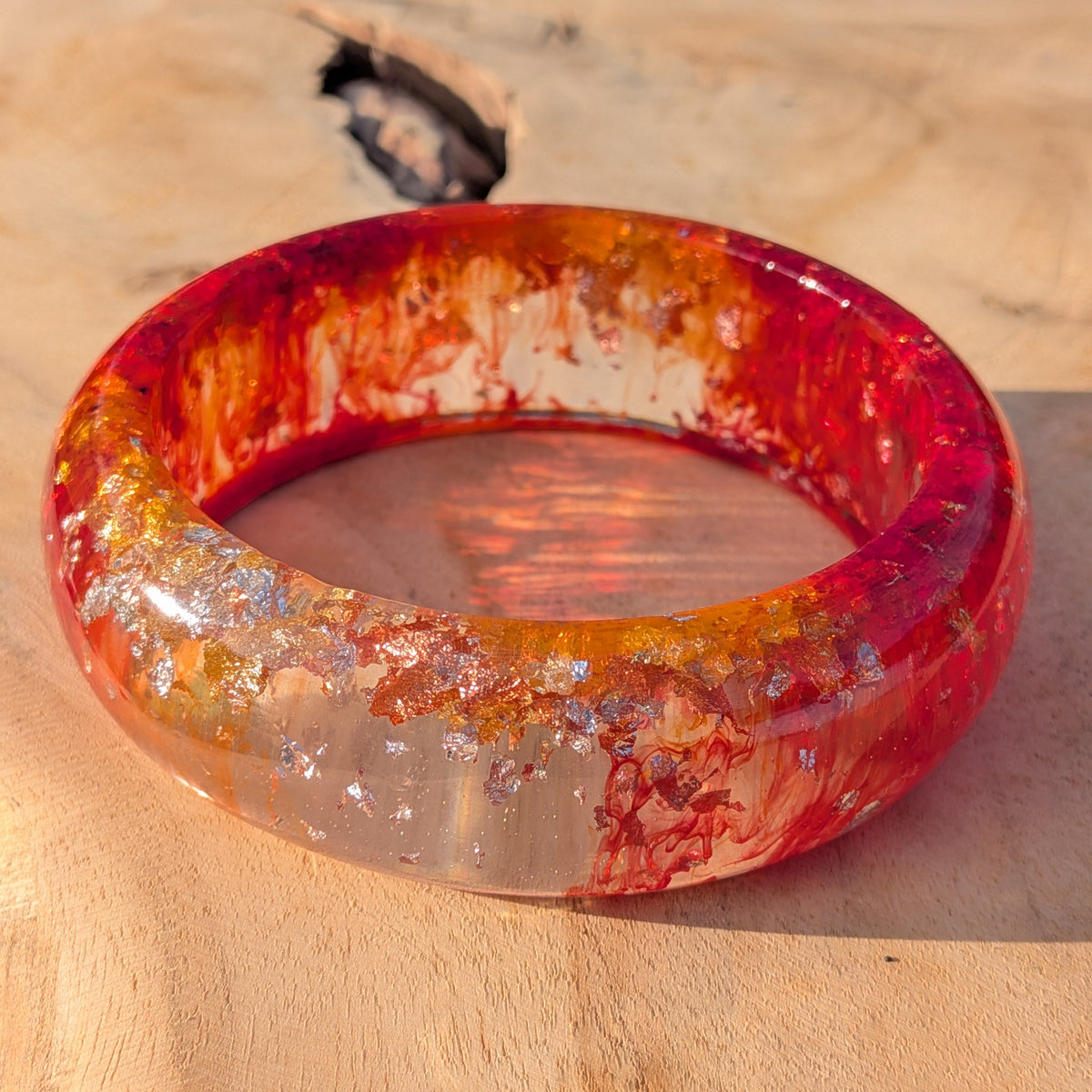 Macro detail of red crimson and orange resin with silver gold leaf in wide bangle – EL-Creations