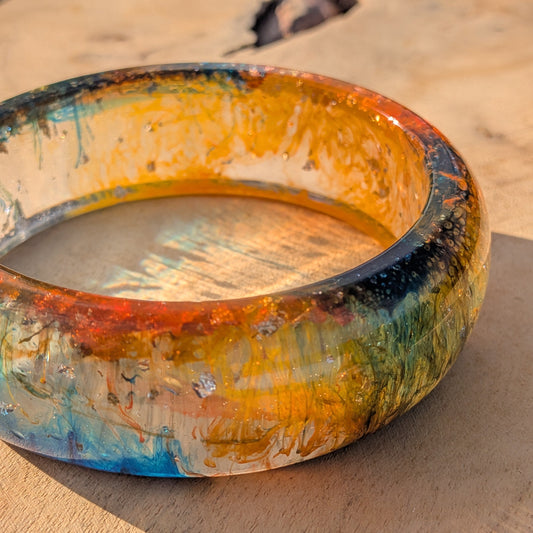 Amber tide resin bangle inner view showing warm orange glow and teal contrast – EL-Creations