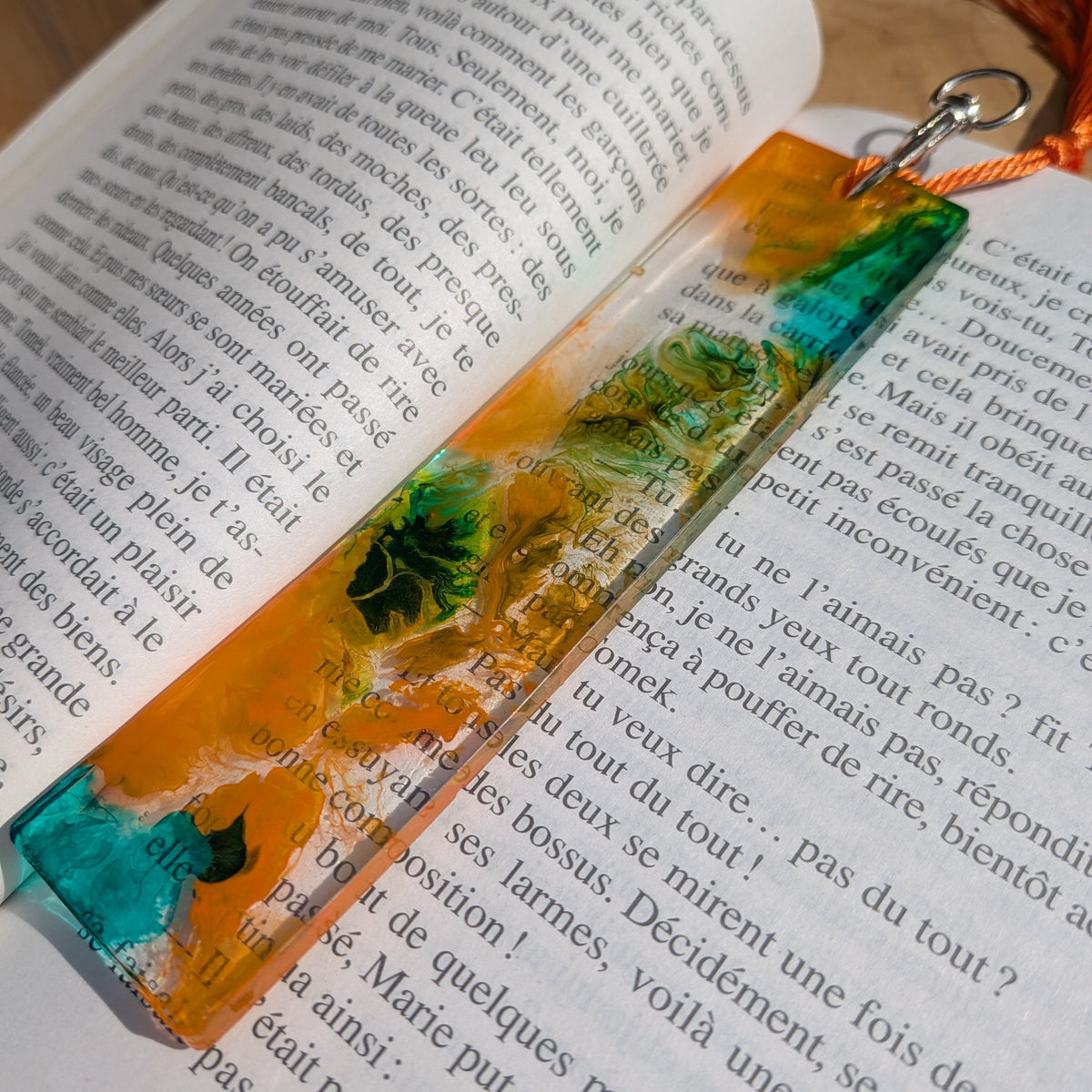 Resin bookmark keychain with lobster clasp and orange tassel on open book – EL-Creations