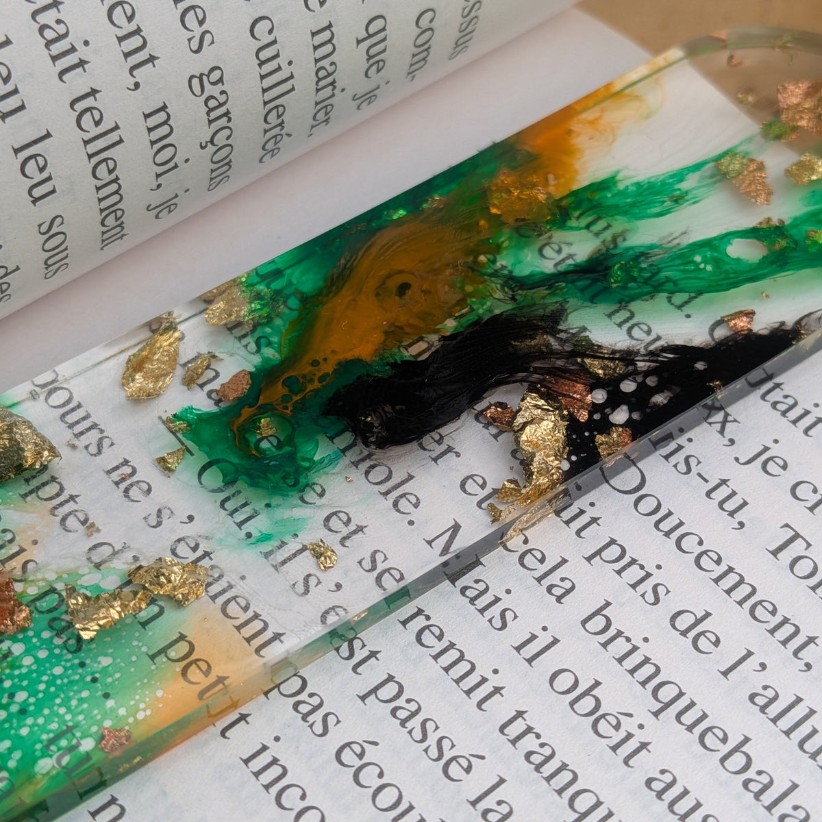 Detail of black and green alcohol ink swirl with gold flakes in resin bookmark – EL-Creations